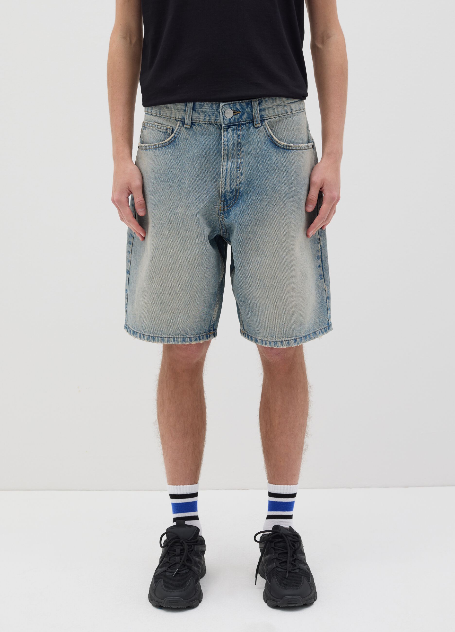 Light blue denim shorts with ripped details