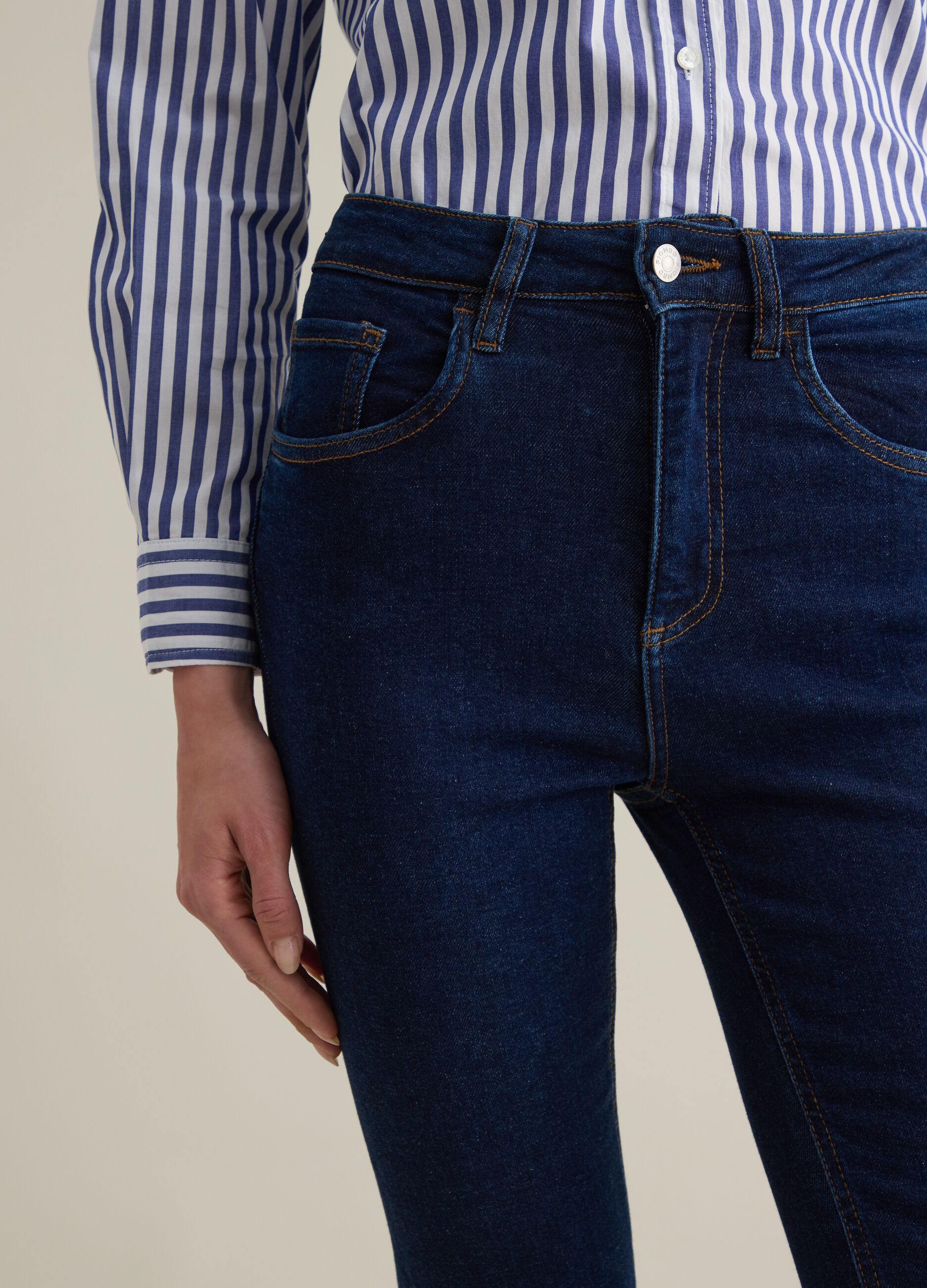 Cropped blue flare-fit jeans with raw edging