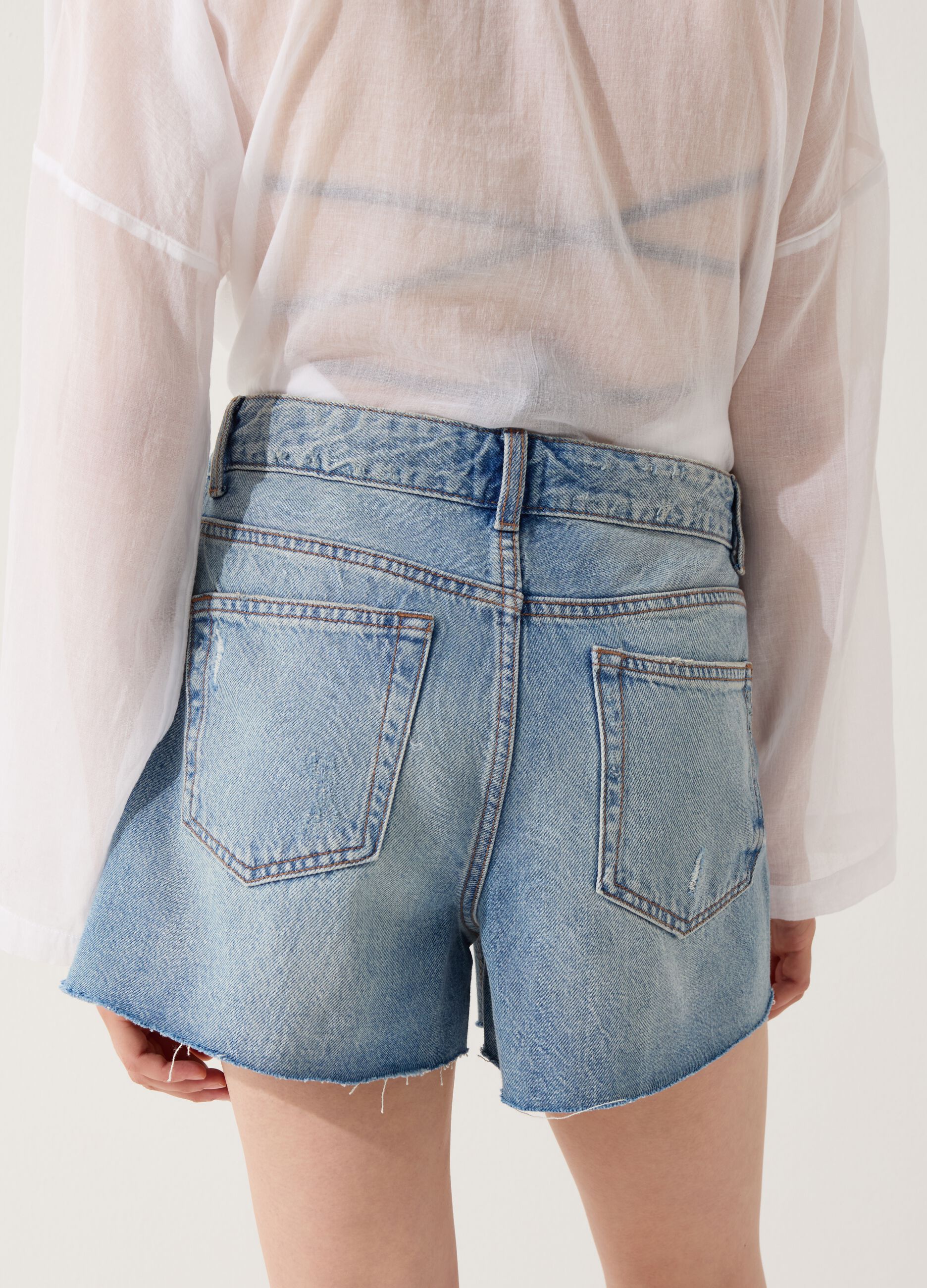 Denim shorts with abrasions