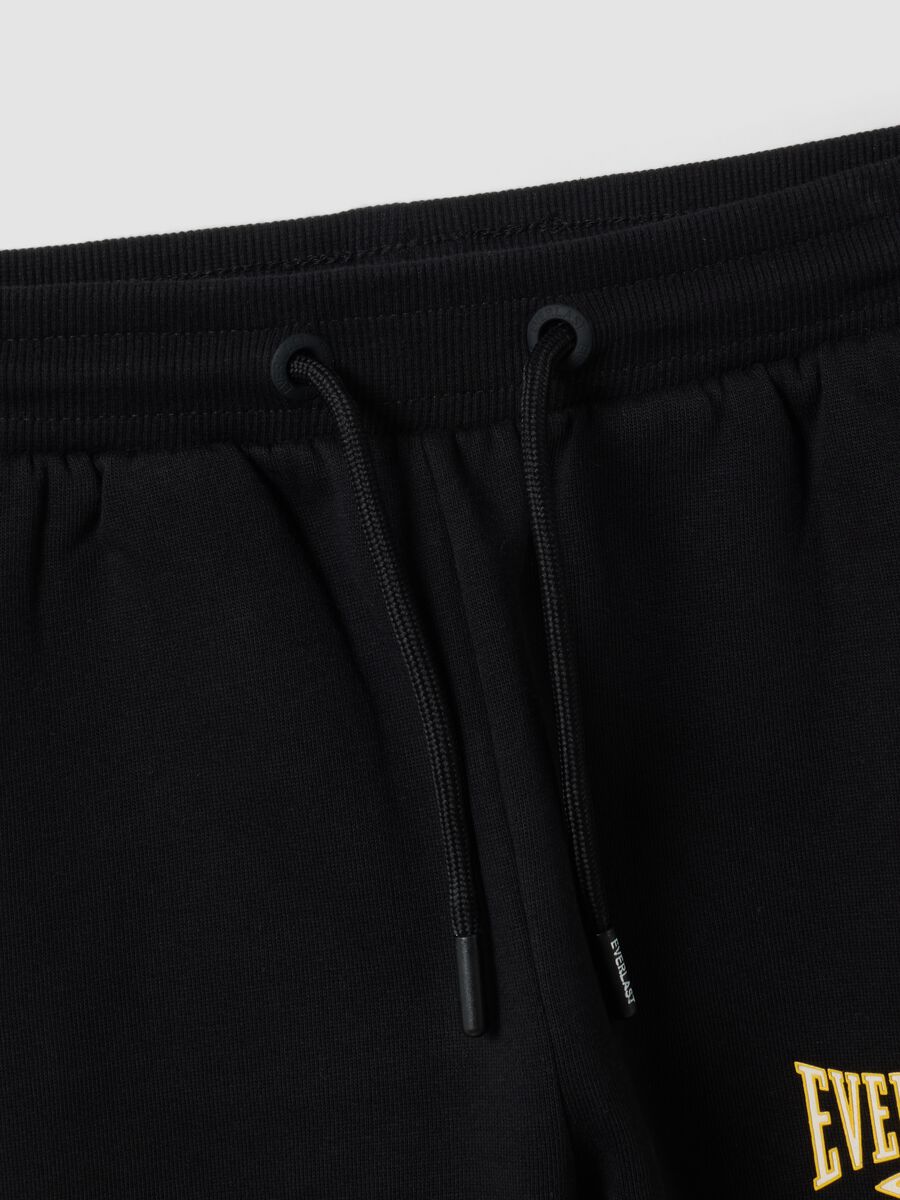 Pantaloni sportivi neri in puro cotone con bande gialle per bambino_3