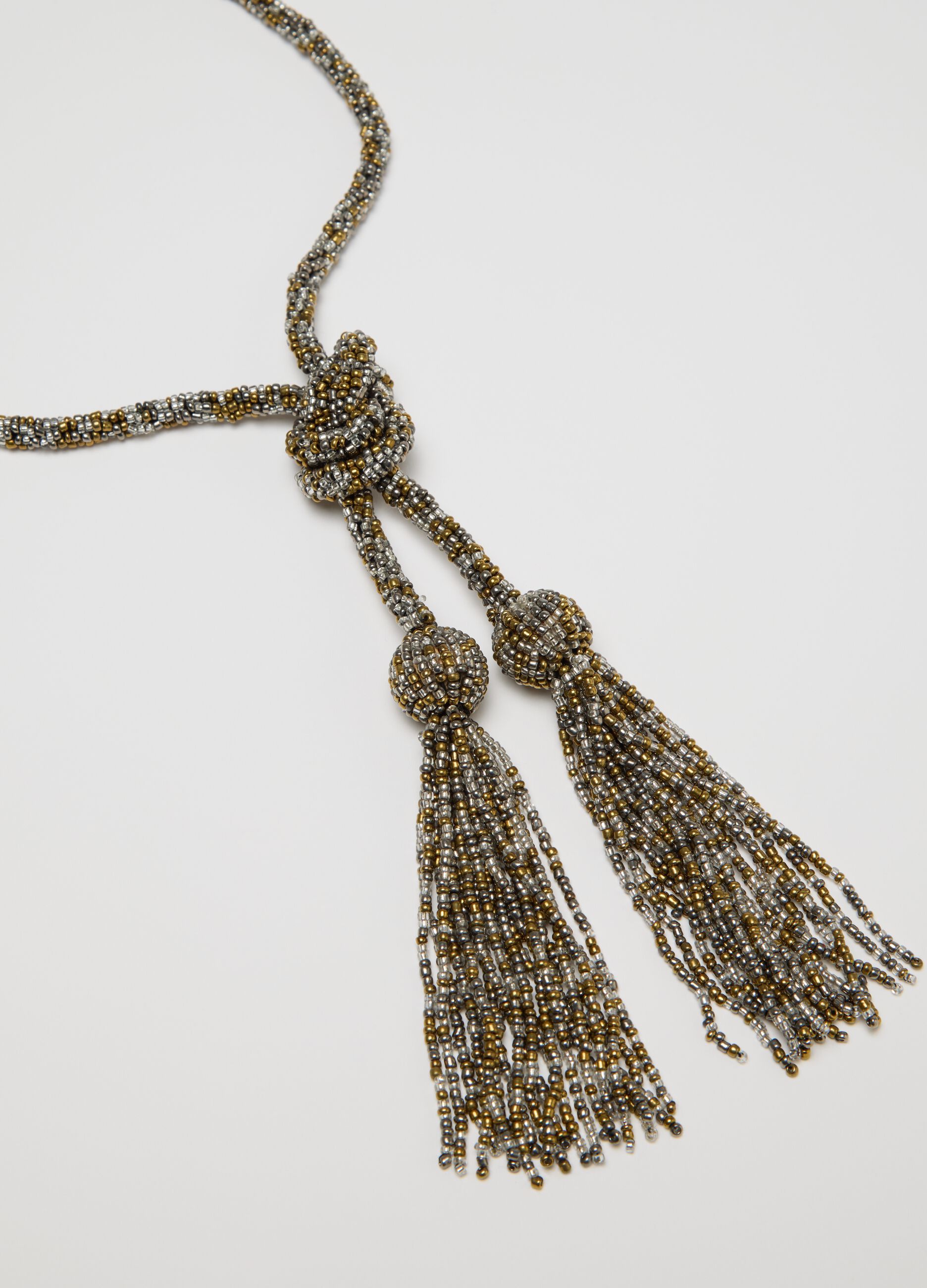 Collana lunga grigio e oro con perline e nappine
