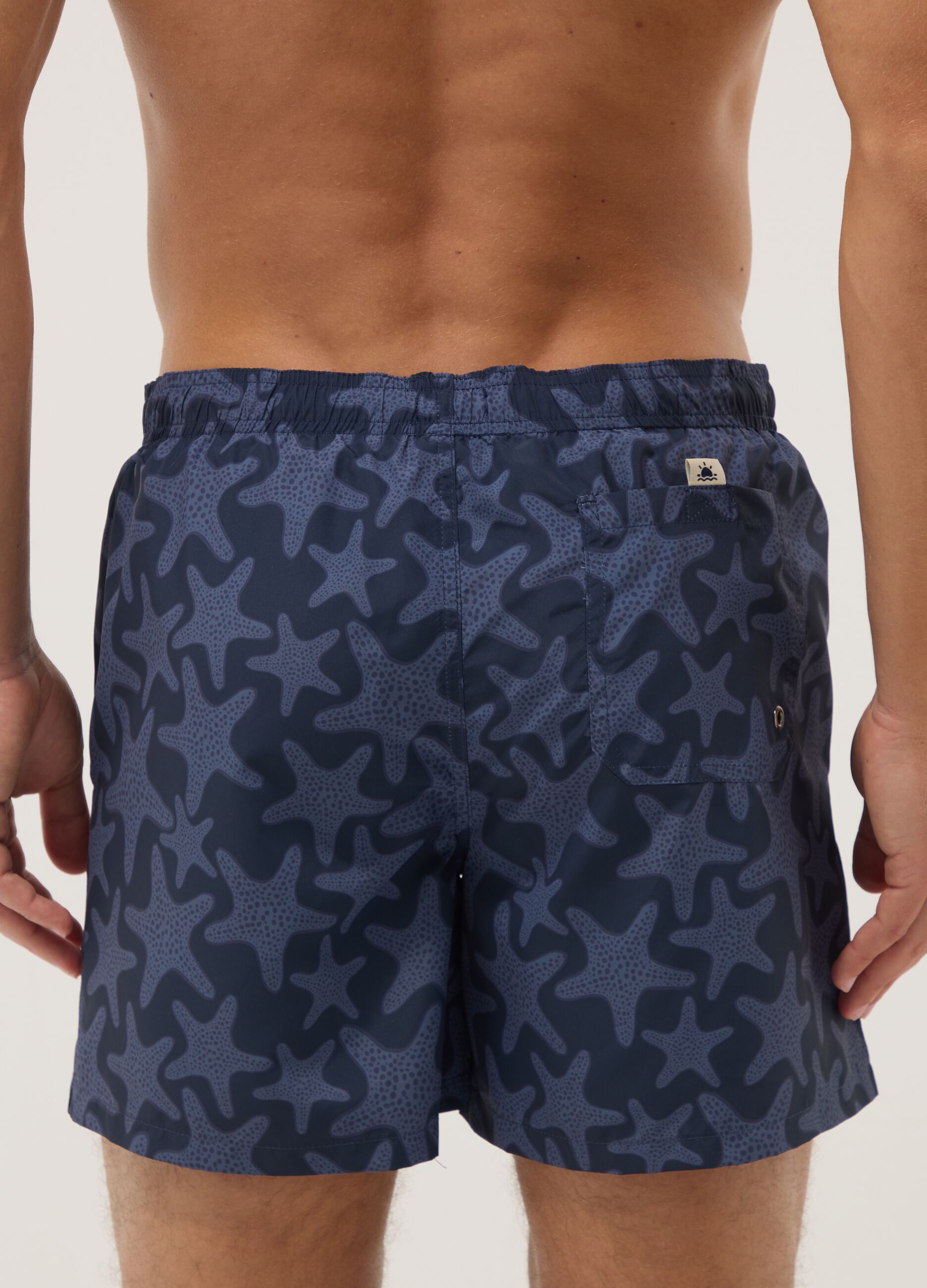 Blue swim shorts with starfish print