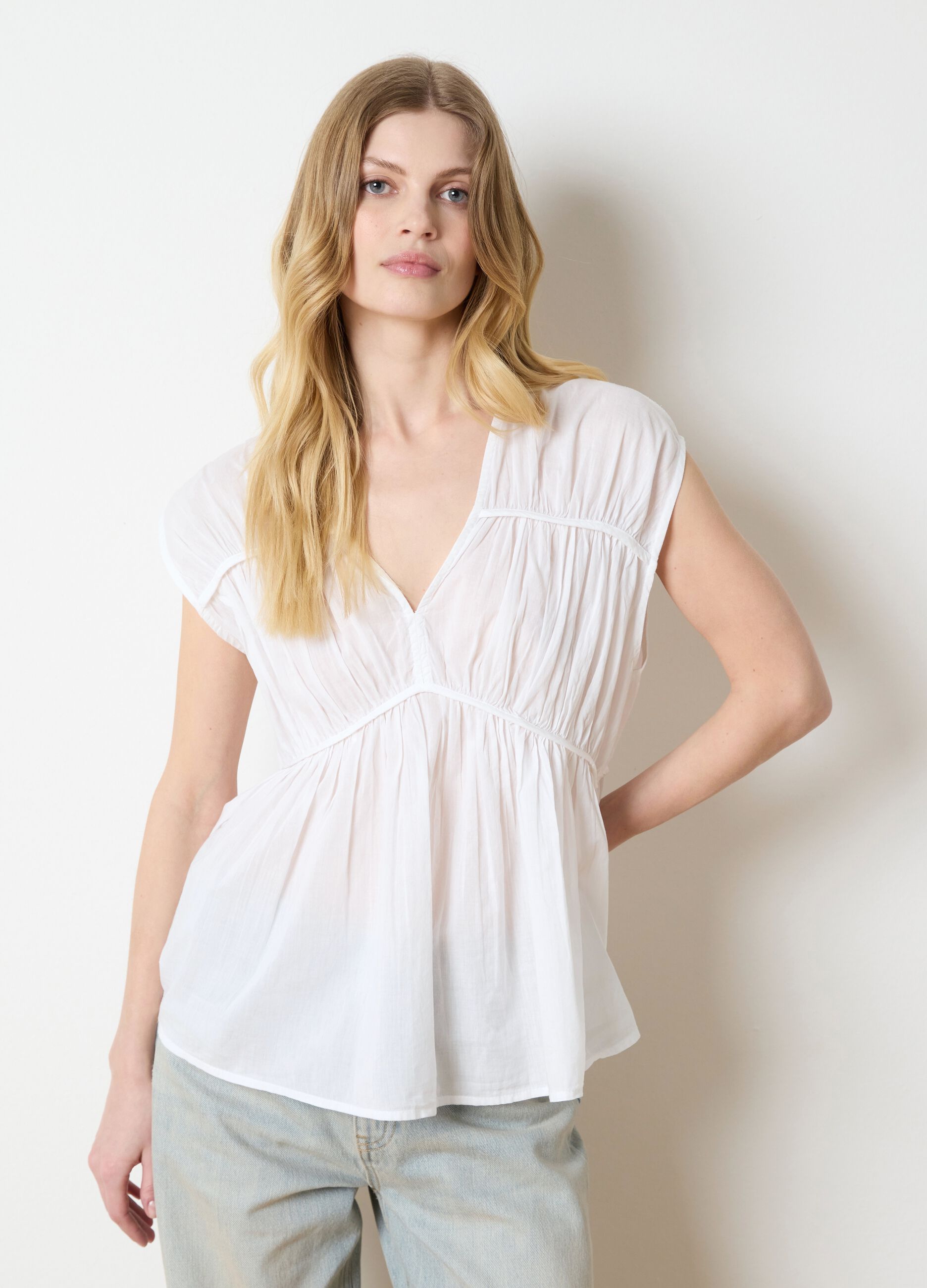 White sleeveless cotton blouse with gathering