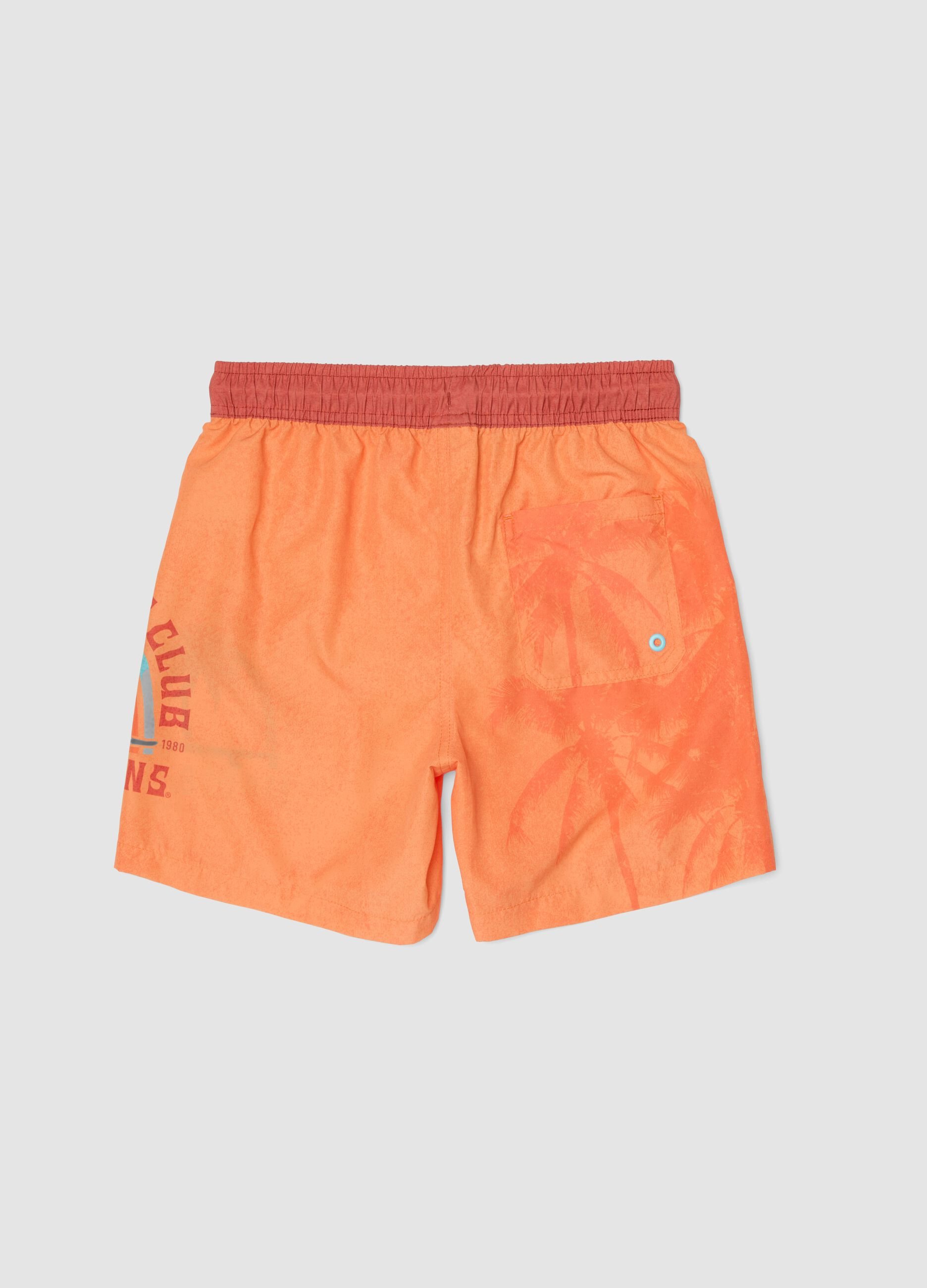 Orange boys&rsquo; swim shorts with tropical print