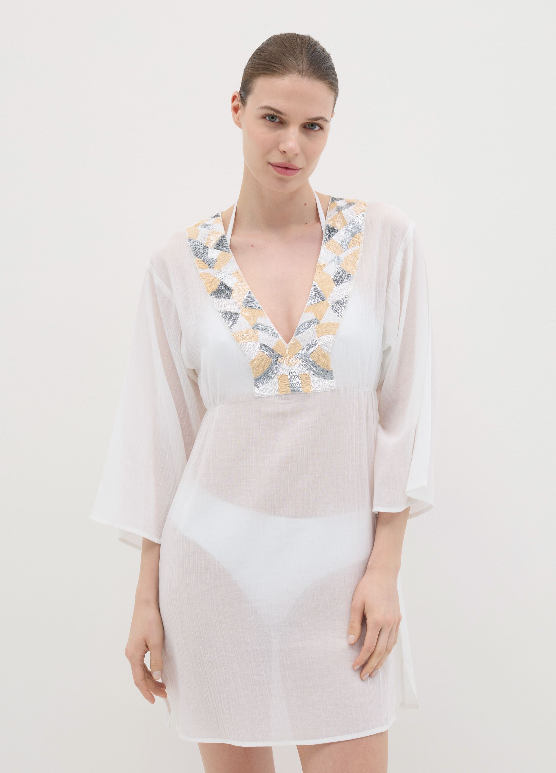 White beach cover-up with decorative edging