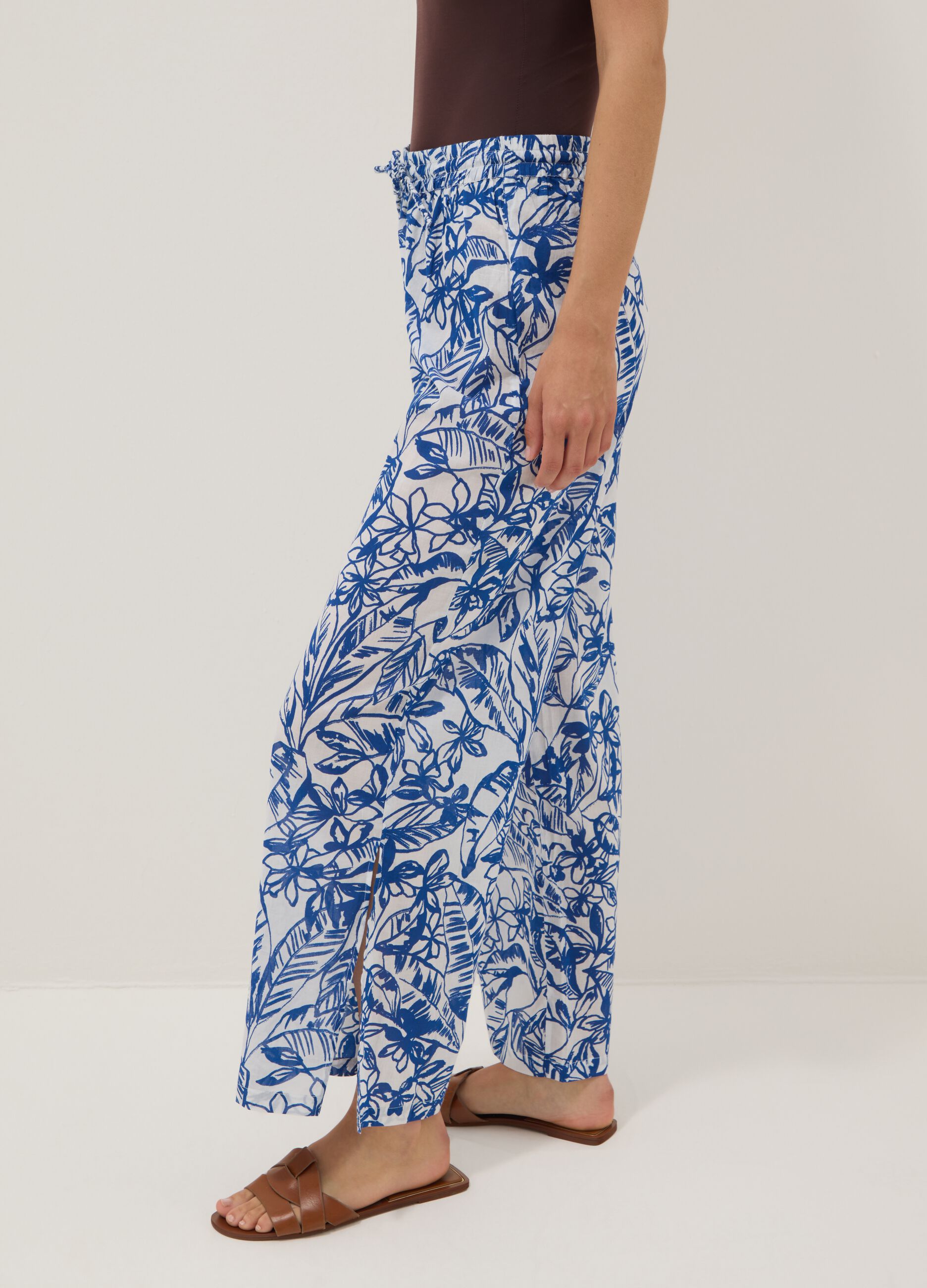 Blue and white organic cotton trousers with floral print