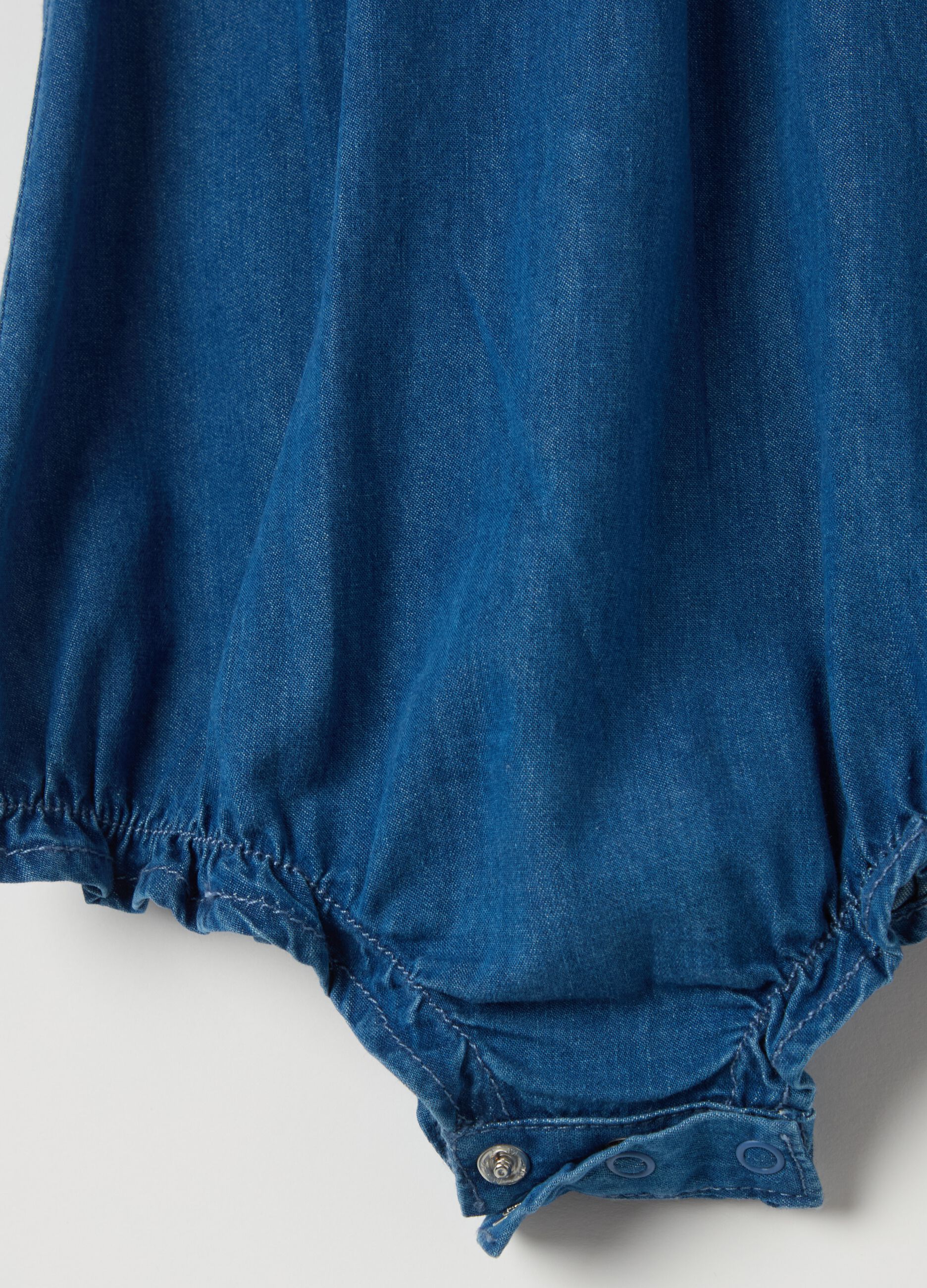 Denim romper suit with floral embroidery