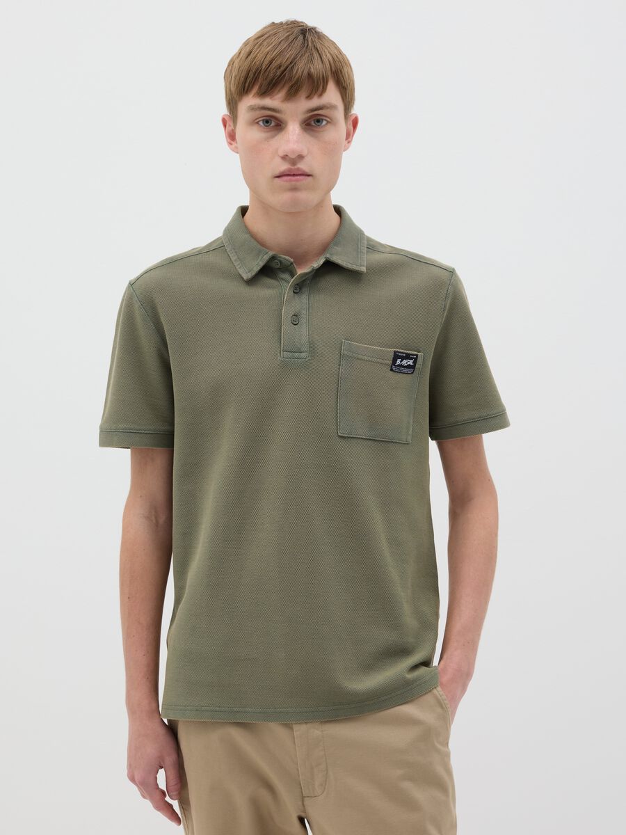 Green short-sleeved polo shirt in cotton piquet_0