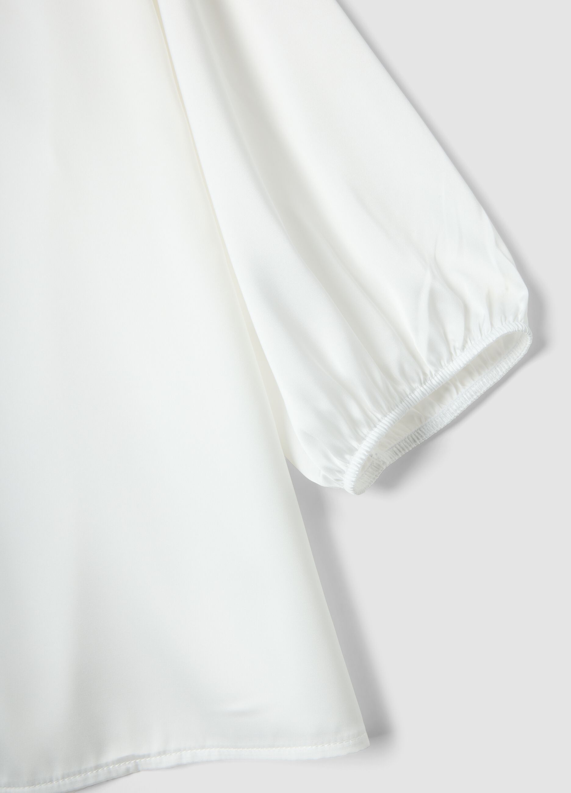 White long-sleeve top with wide sleeves