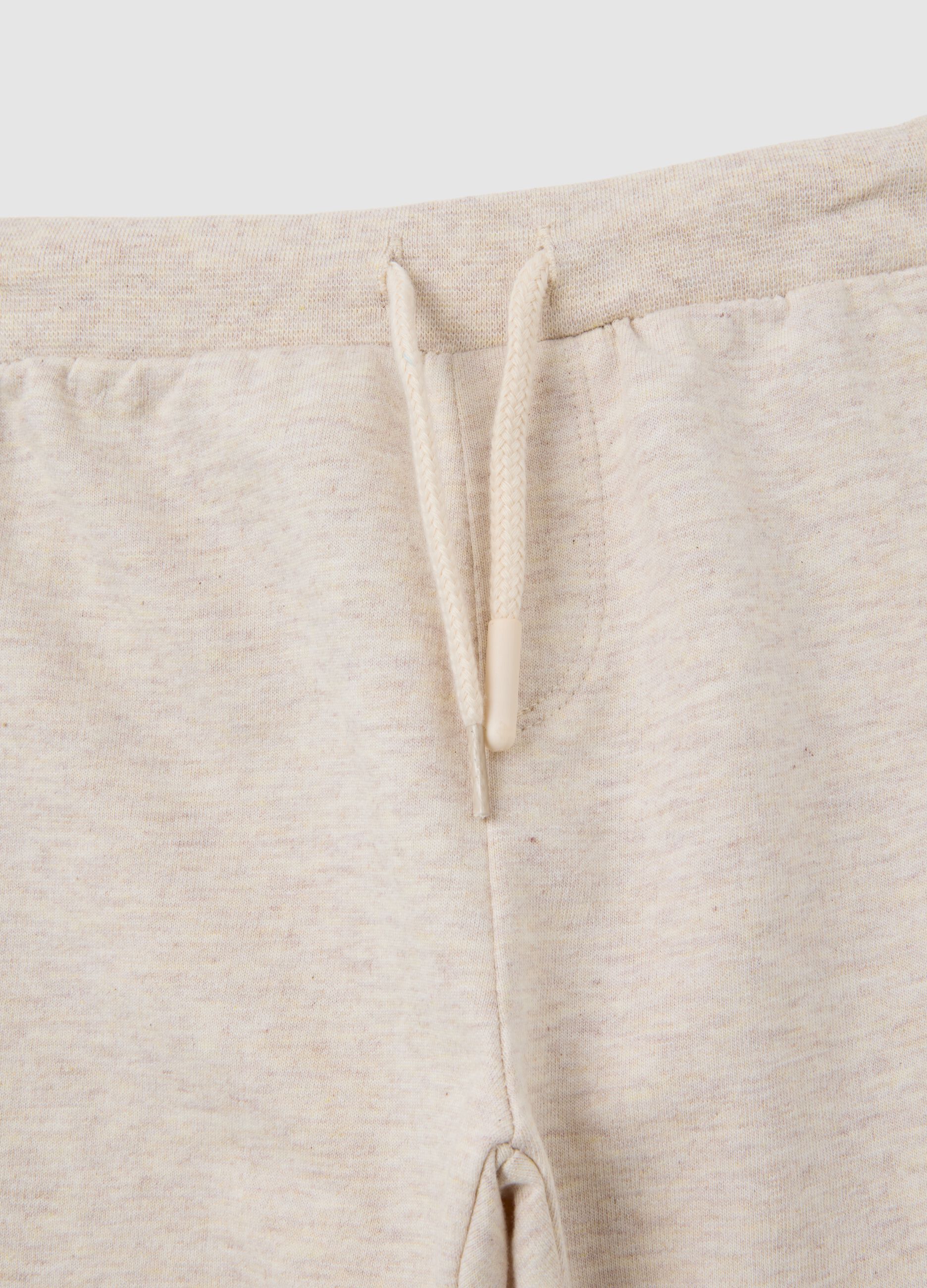 Set of child's t-shirt and trousers in pure white and beige cotton