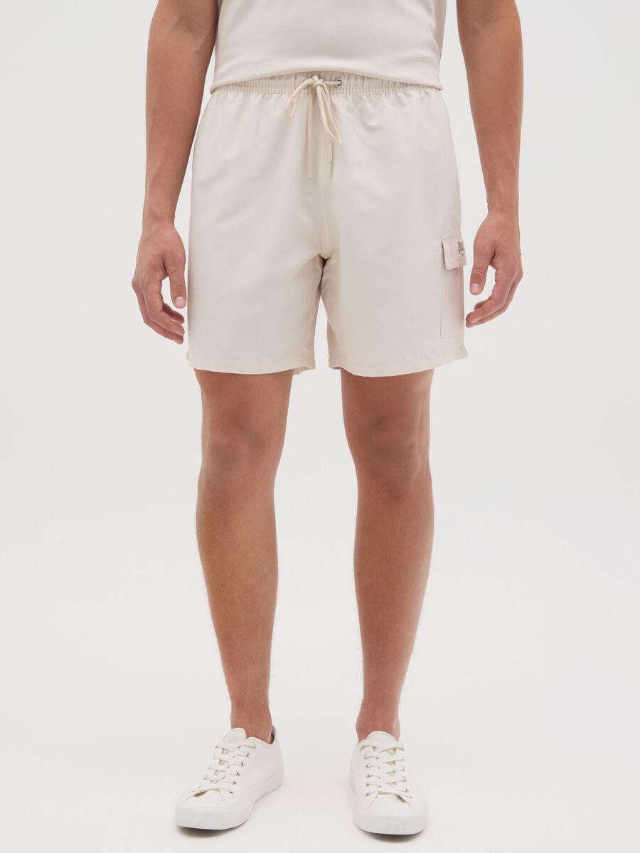 Beige swimming trunks with logo print_1