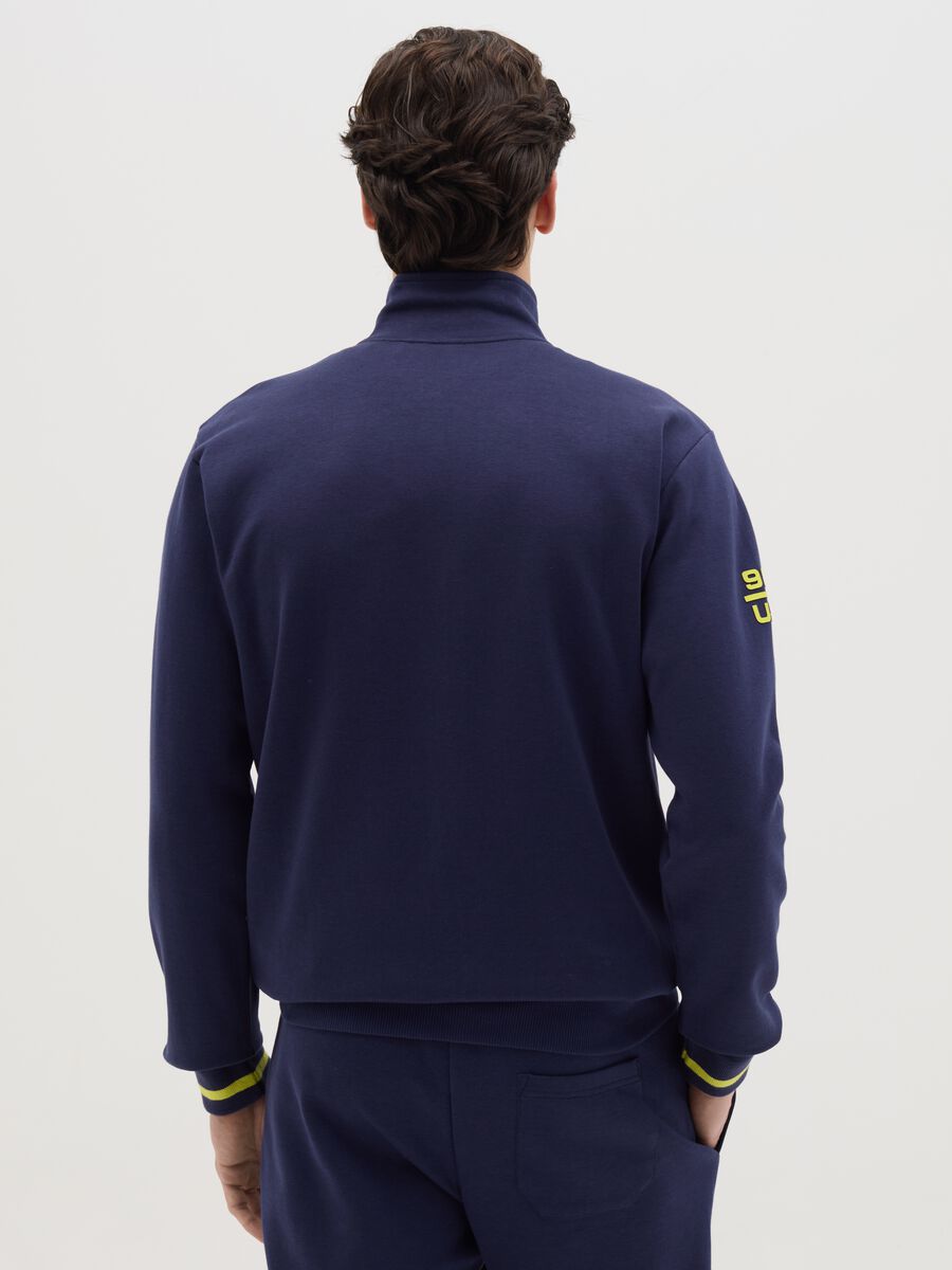 Blue full-zip sweatshirt with yellow details and logo_3