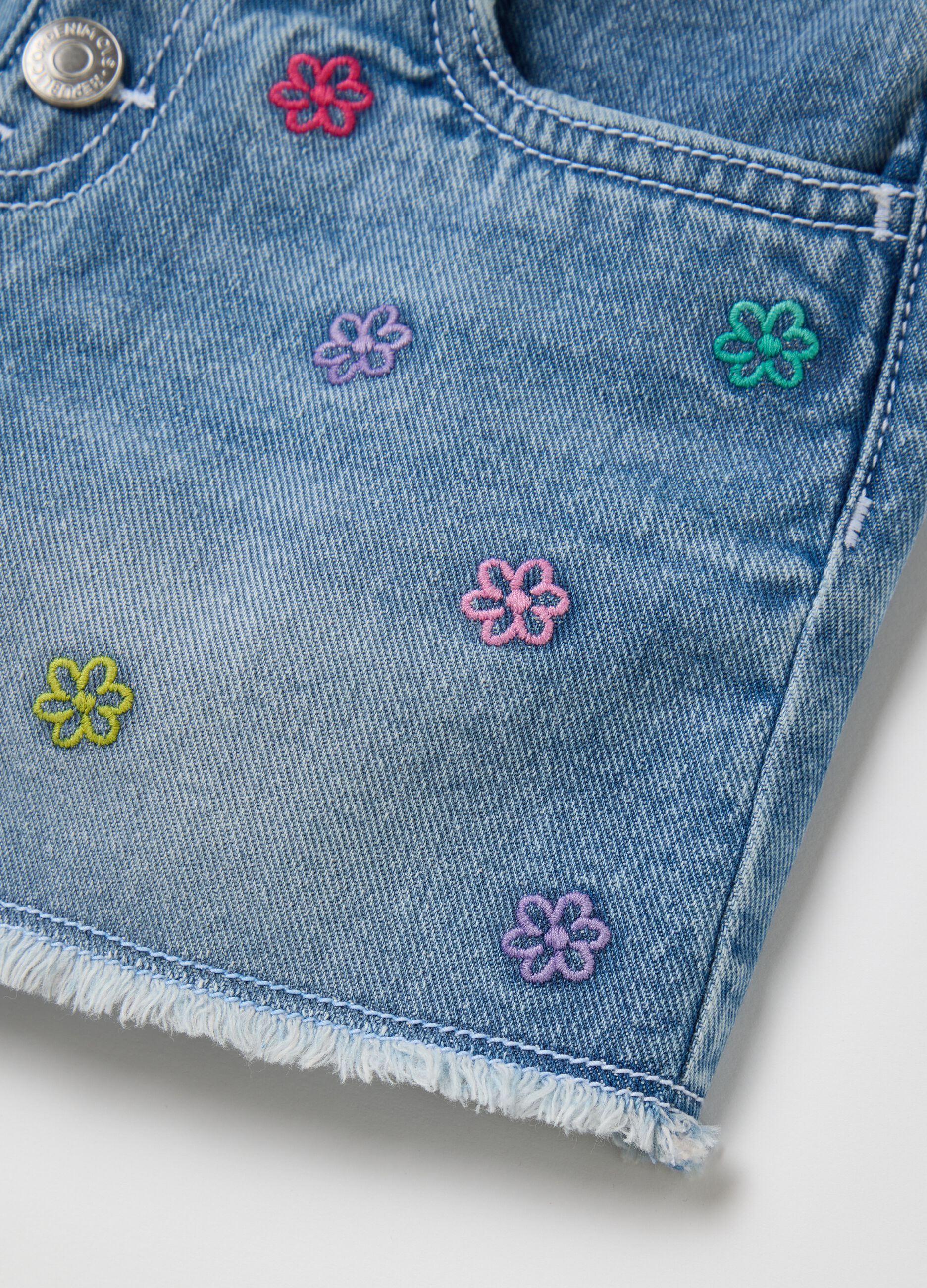 Light blue denim shorts with floral embroidery