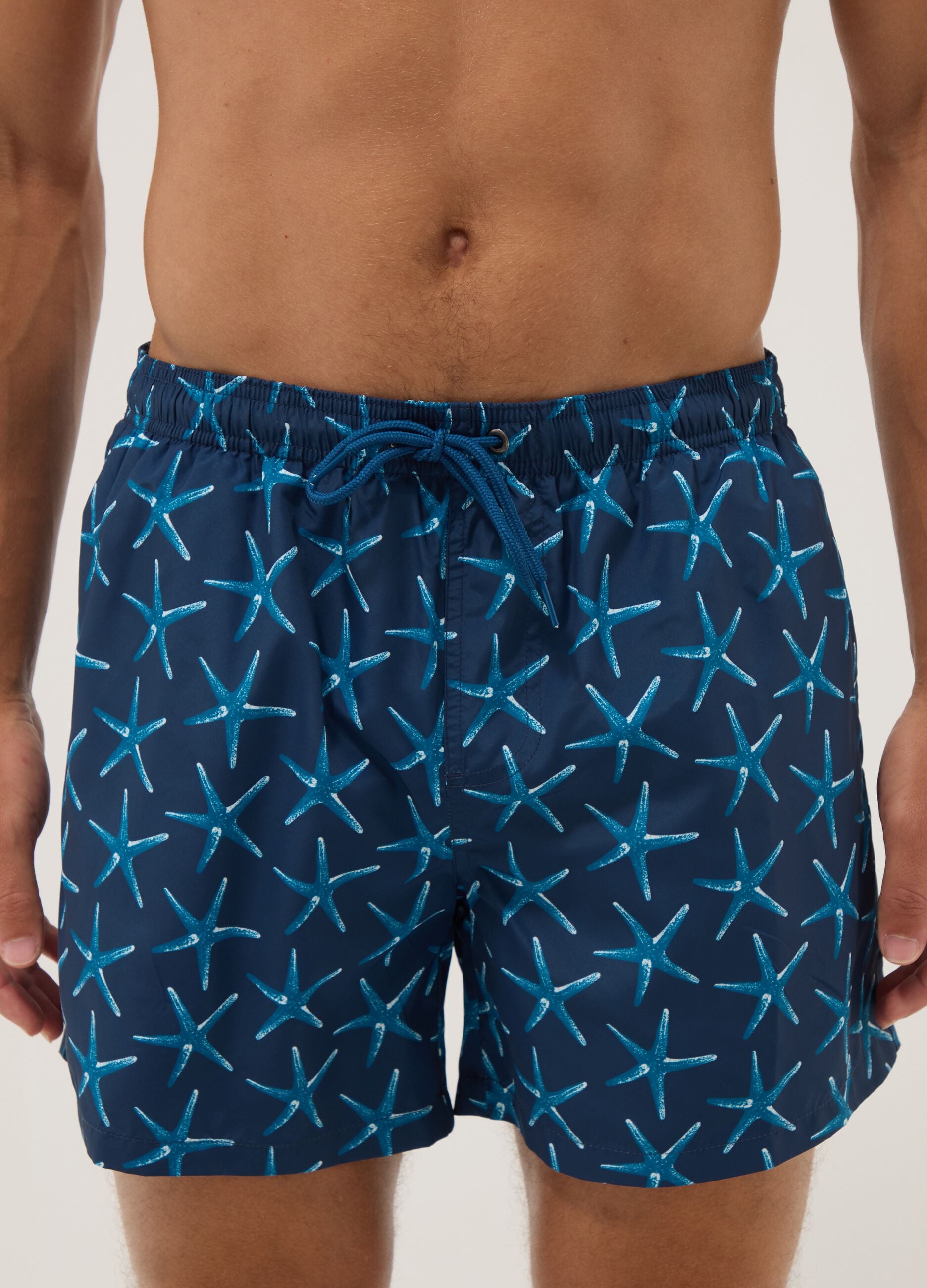 Blue boxer swim shorts with starfish print