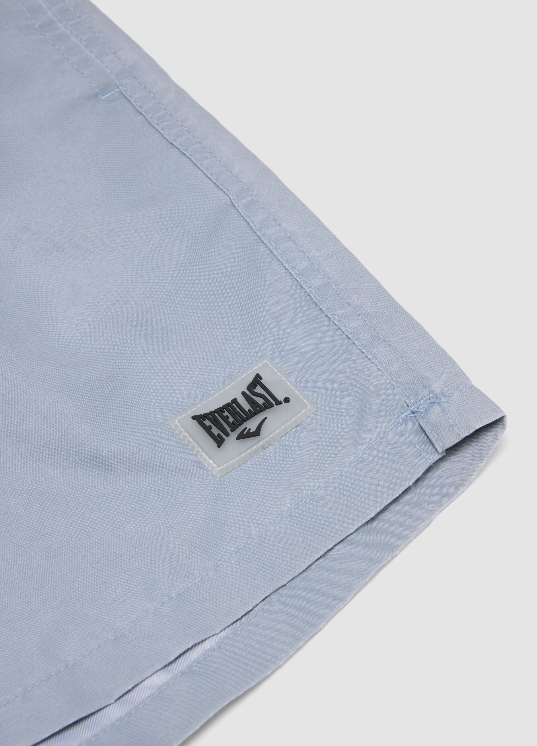 Blue swim shorts with drawstring waist