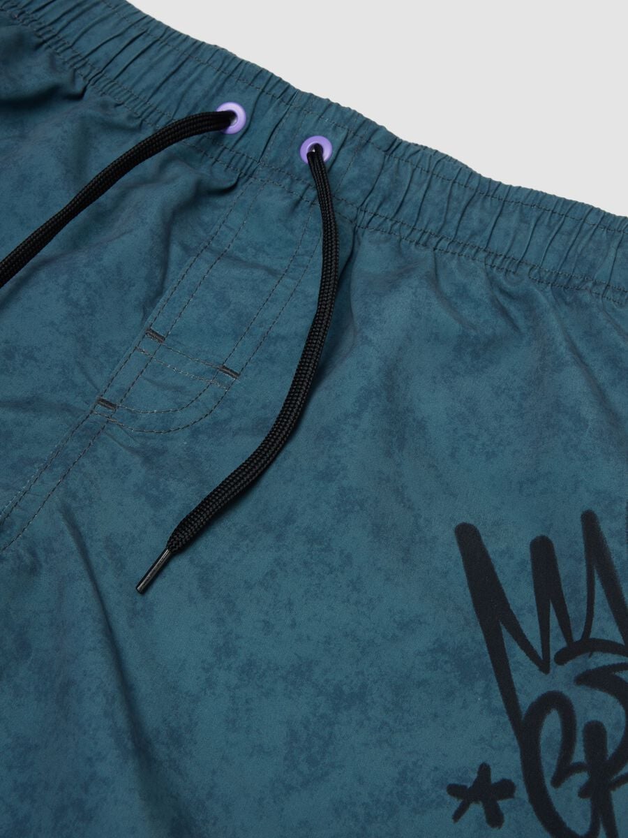Blue swim shorts with print_2
