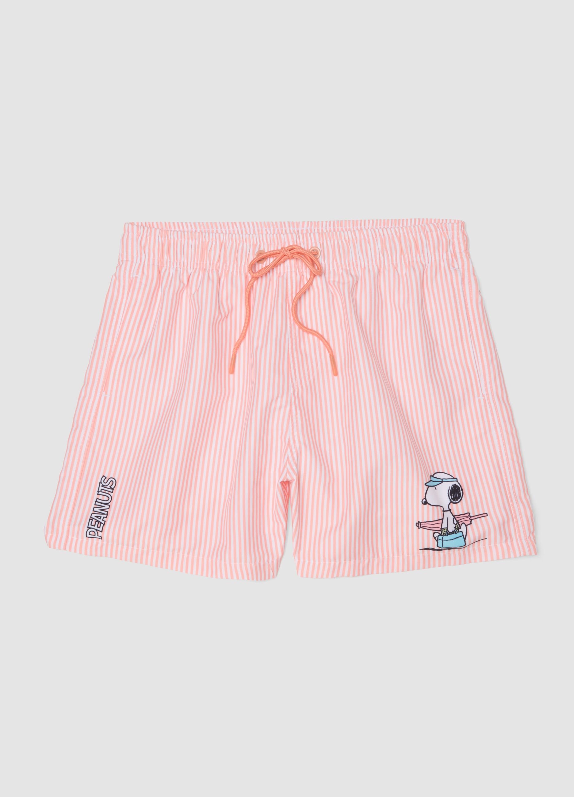 White and pink striped swim trunks with Peanuts print
