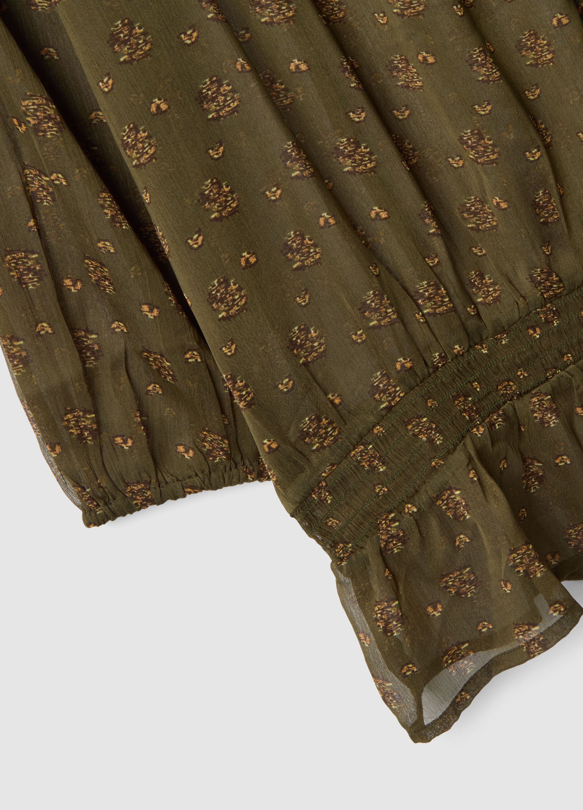 Green maternity blouse with boat neckline and fantasy print