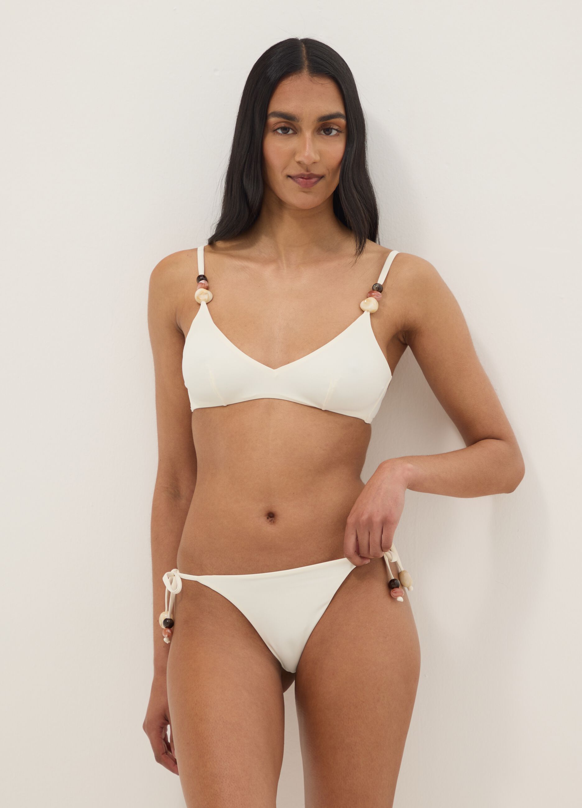 White stretch bikini bottoms with side ties and stones
