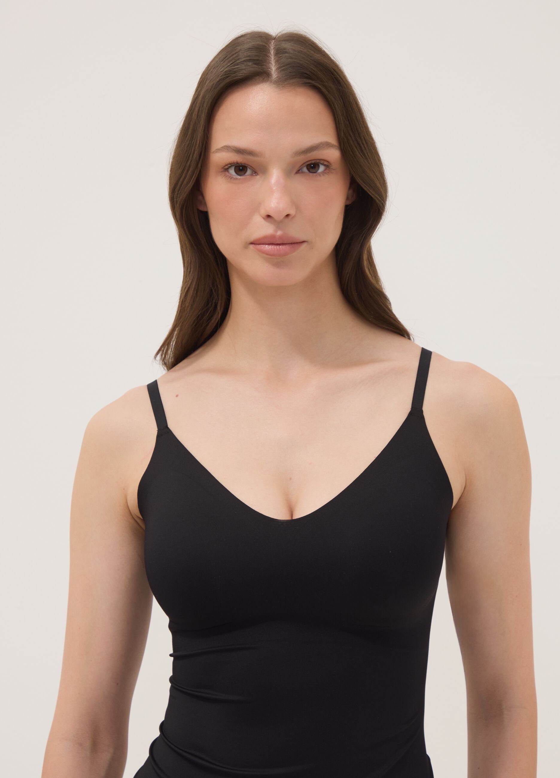 Black stretch-fabric vest top with plunging neckline
