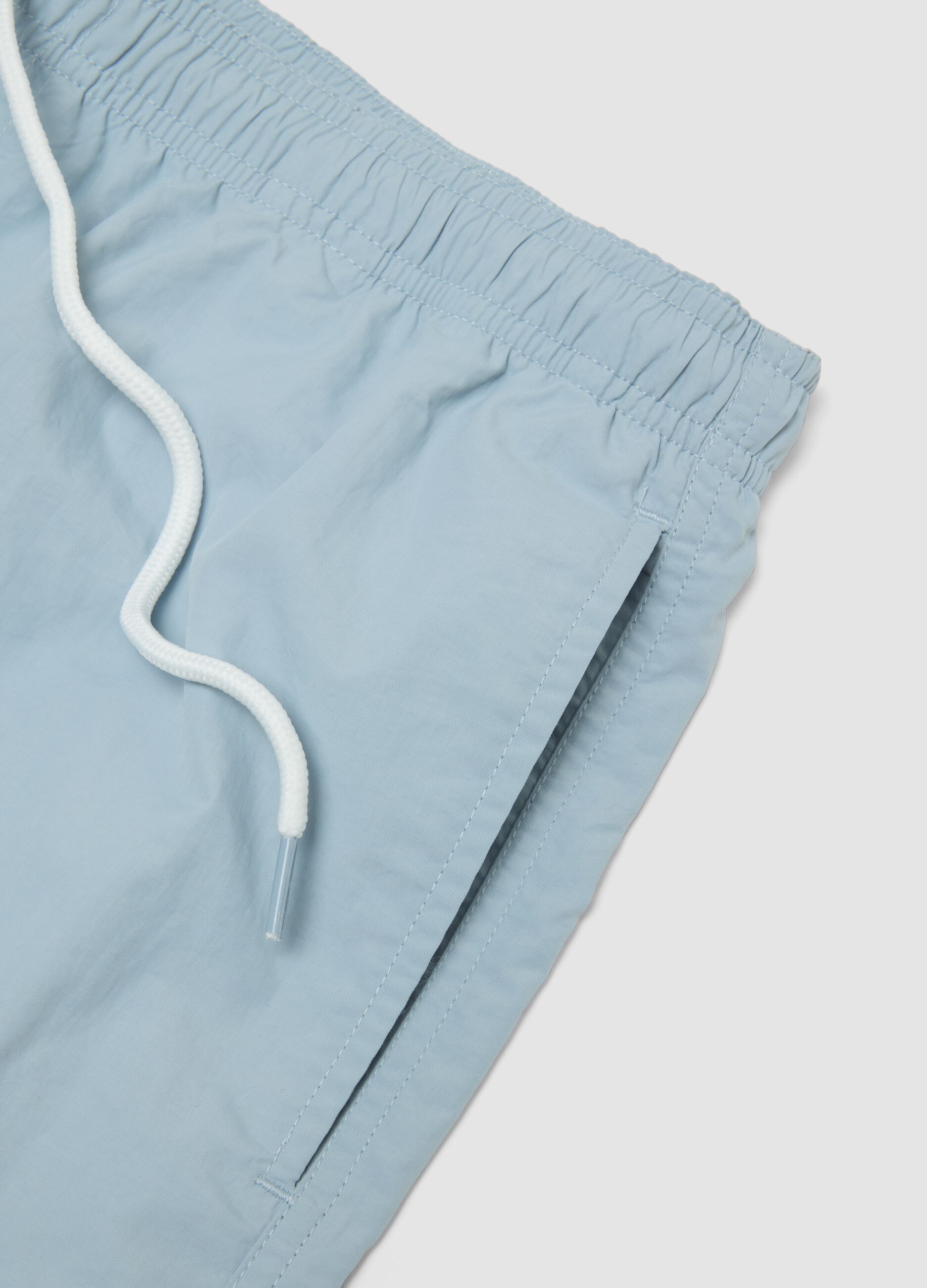 Blue swim shorts with elasticated waistband