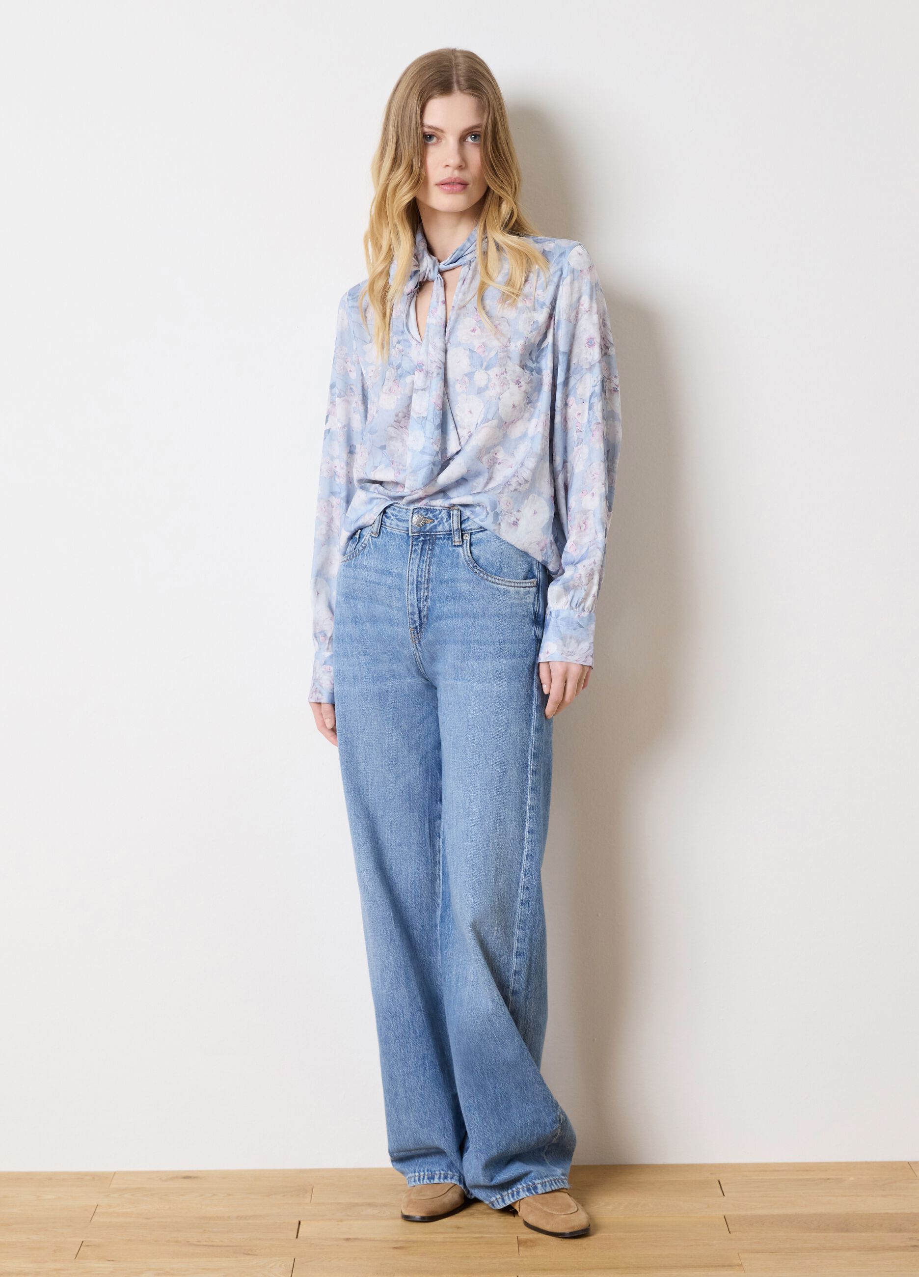 Light blue blouse with floral pattern and bow