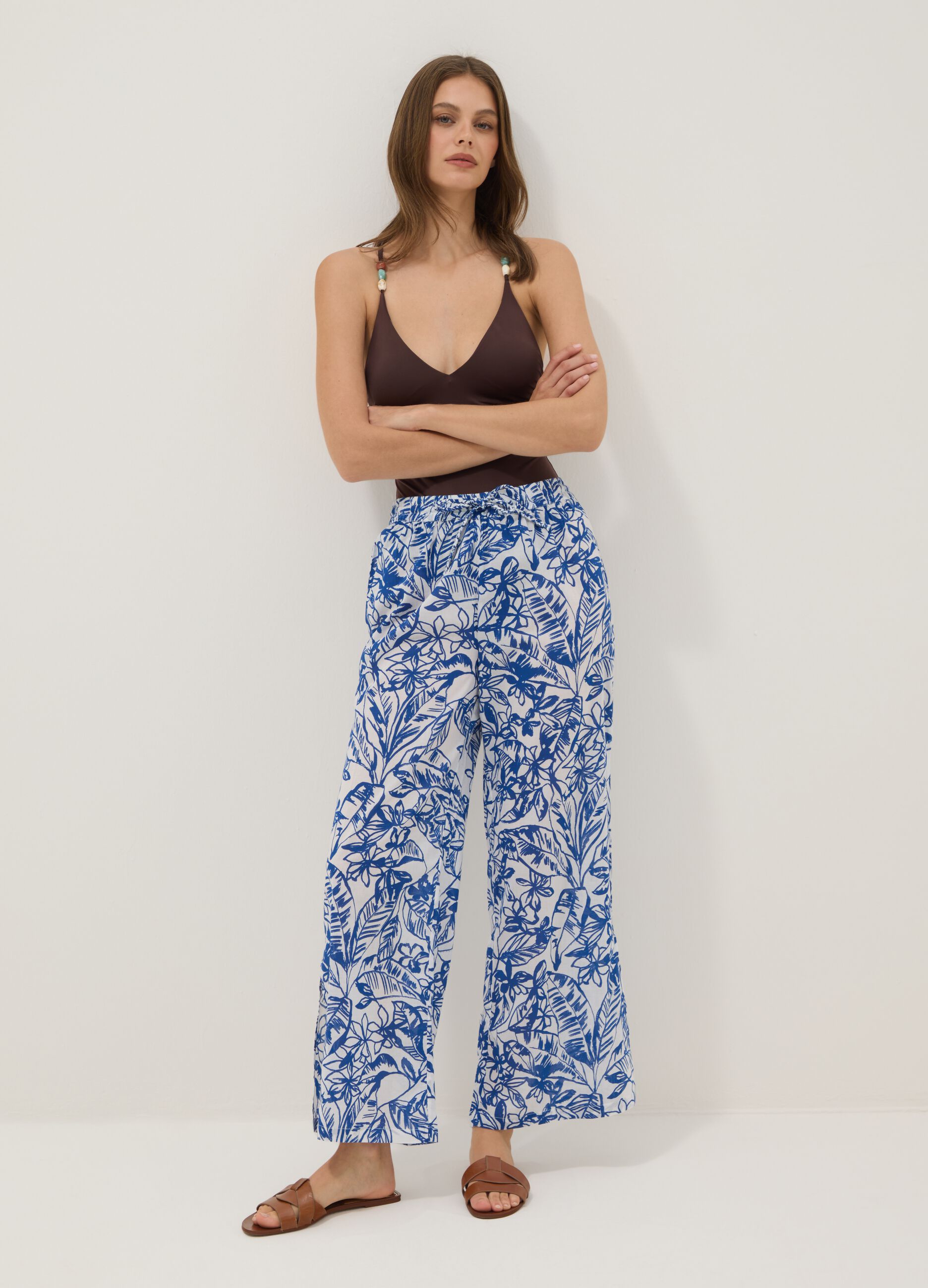 Blue and white organic cotton trousers with floral print