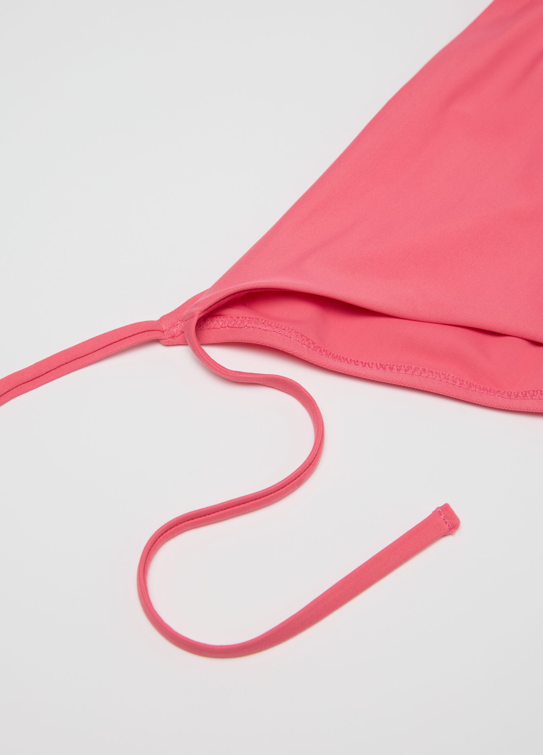 Women’s bikini briefs in pink stretch blend with side ties.