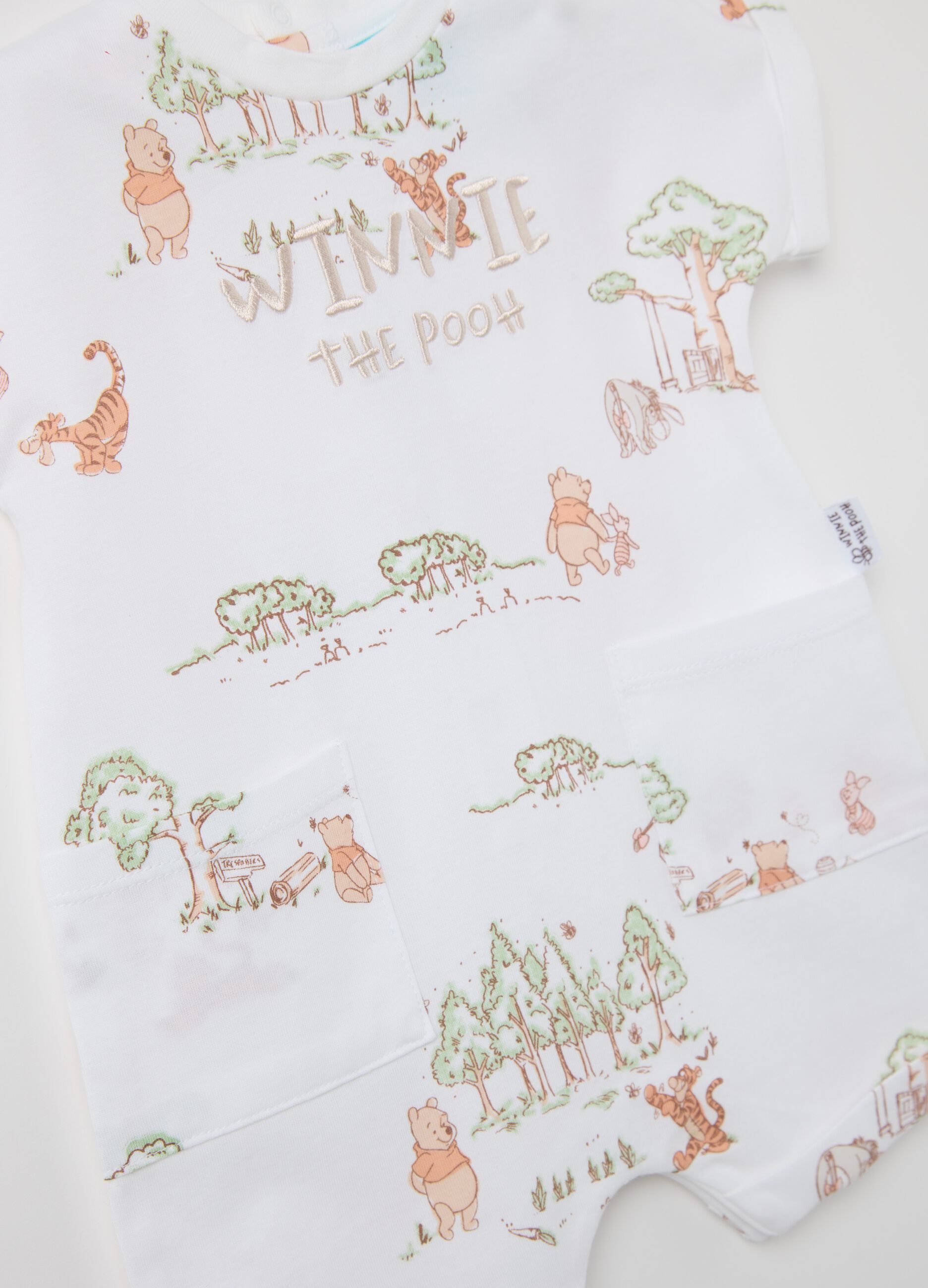 White romper suit in cotton with Winnie the Pooh embroidery and print