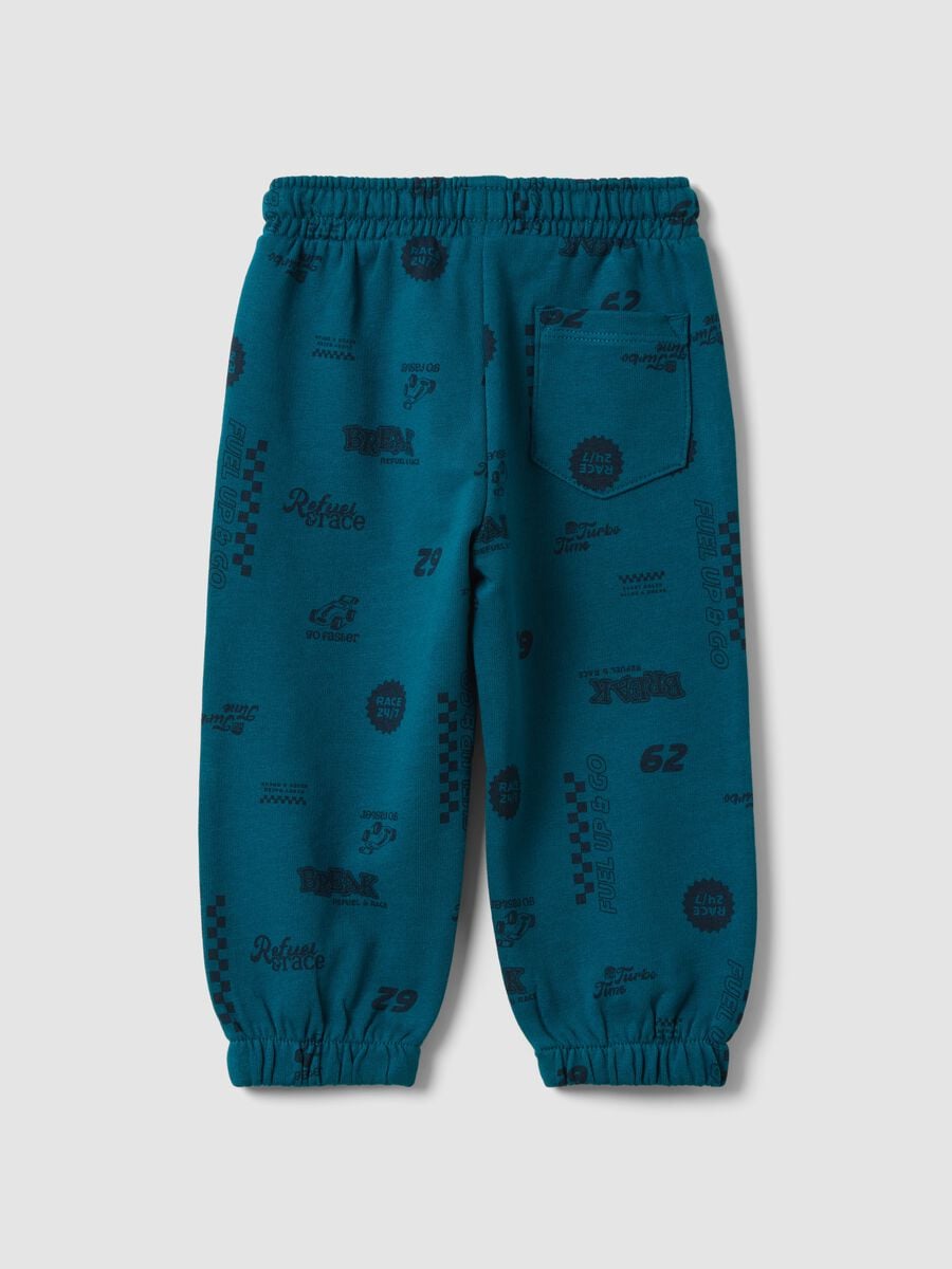 Pantaloni jogger blu in puro cotone con stampa all over_1
