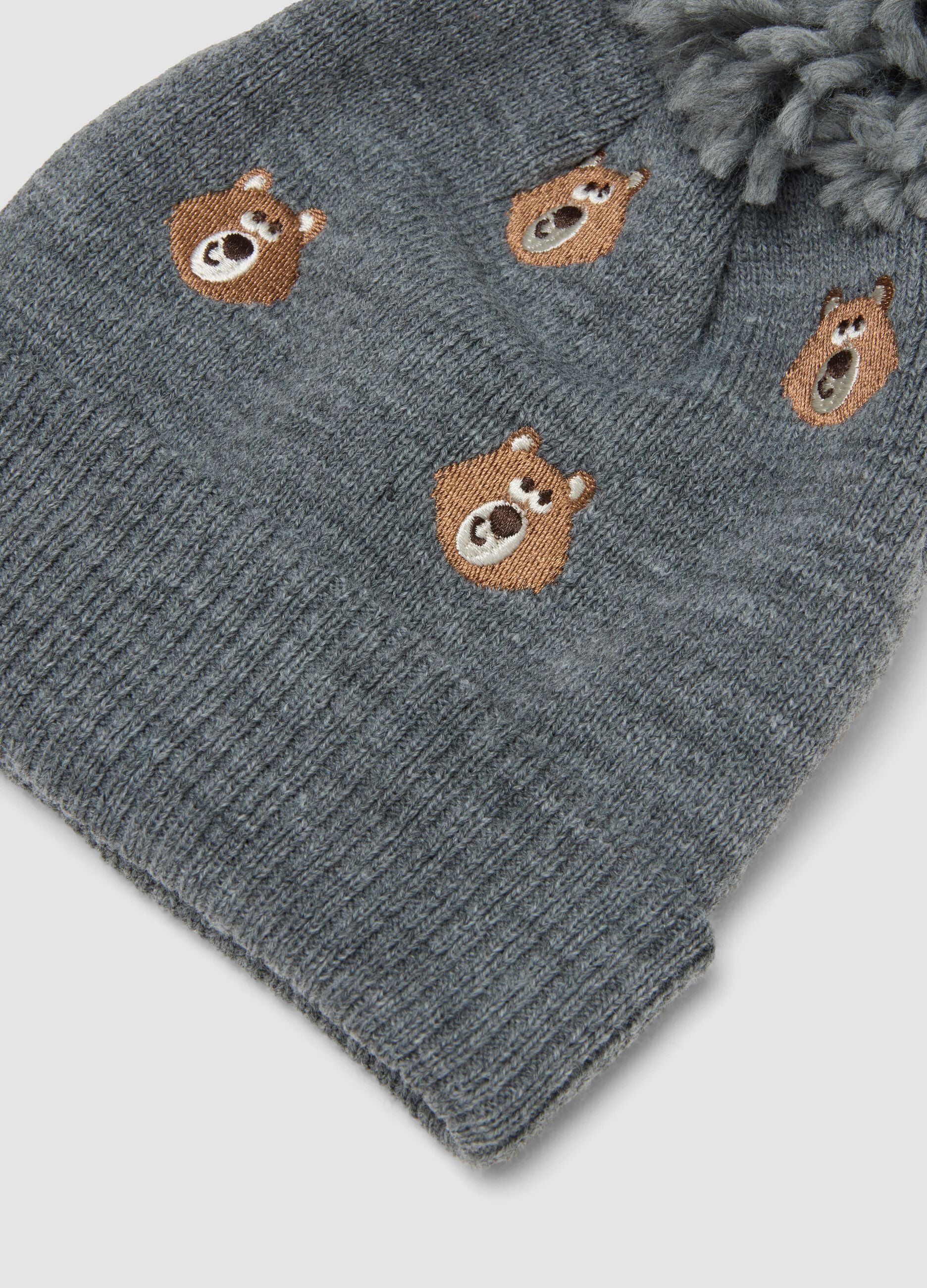 Grey knitted hat with pom pom and teddy bear pattern