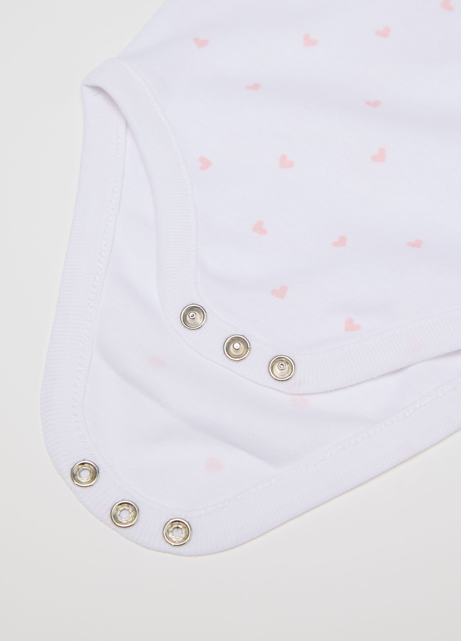 Three-pack white and pink bodysuits in organic cotton with print