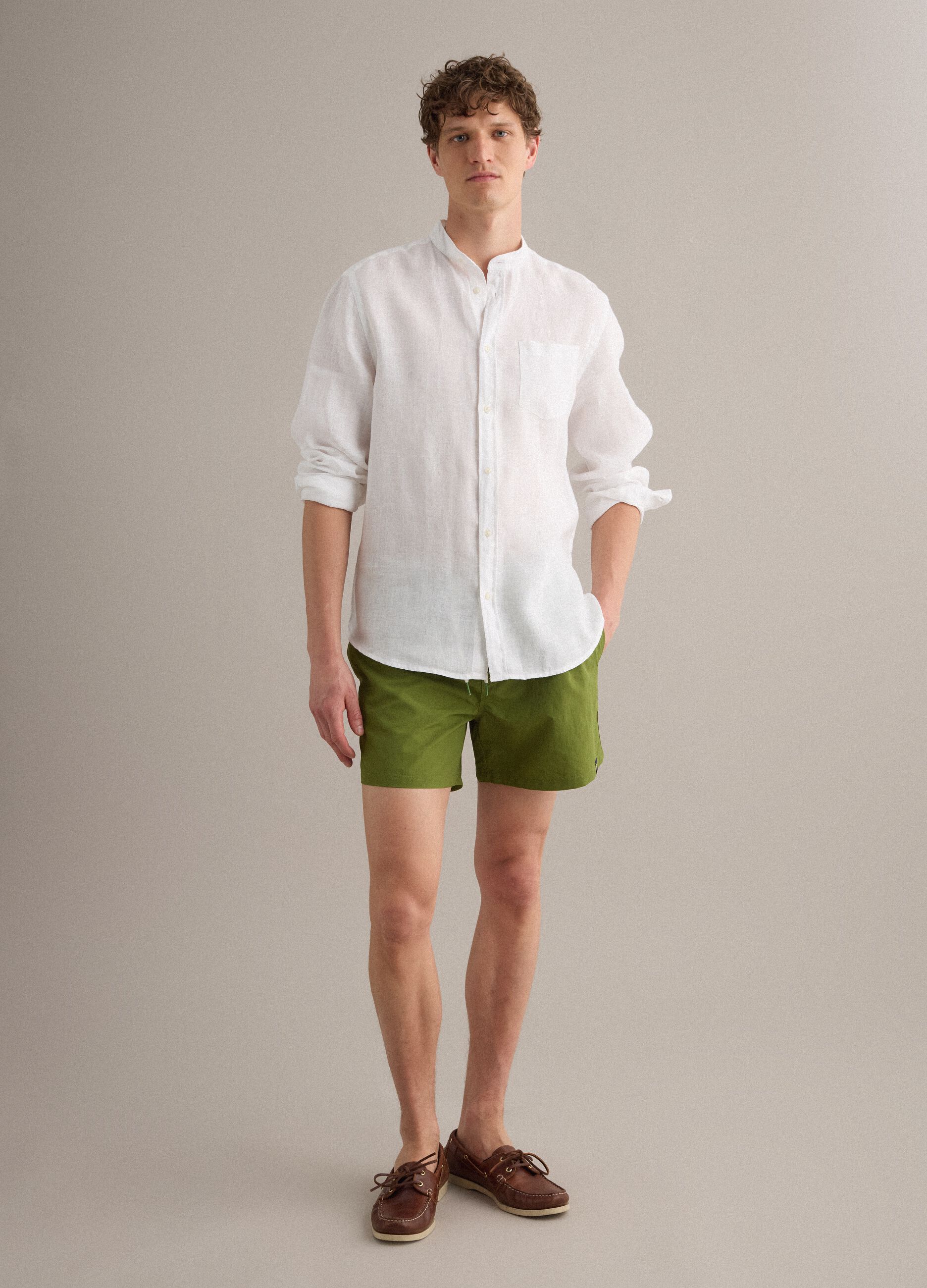 Green swim shorts with elasticated waistband and drawstring