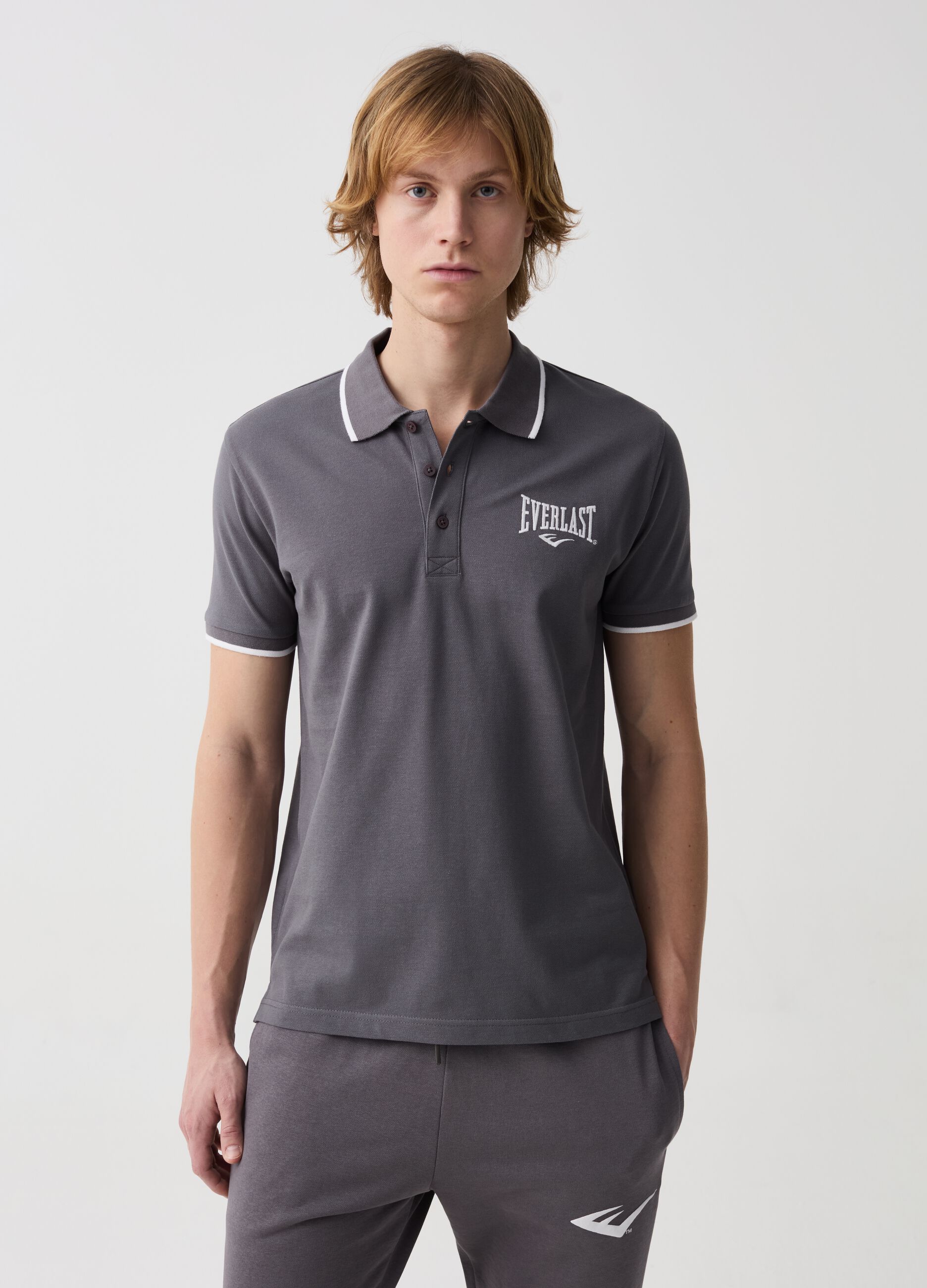 Polo shirt with striped edging and logo embroidery