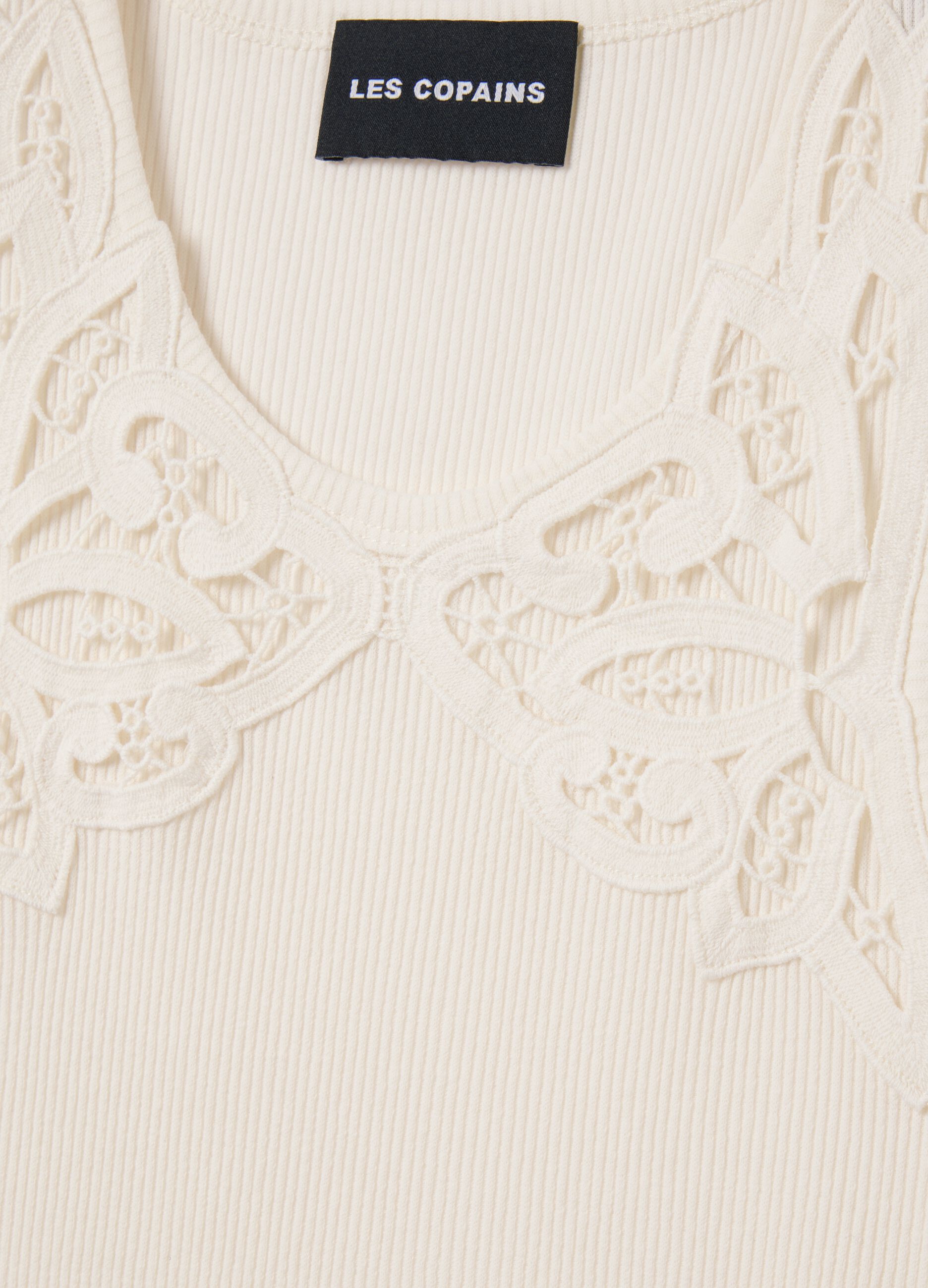 Ivory sleeveless top with embroidered details