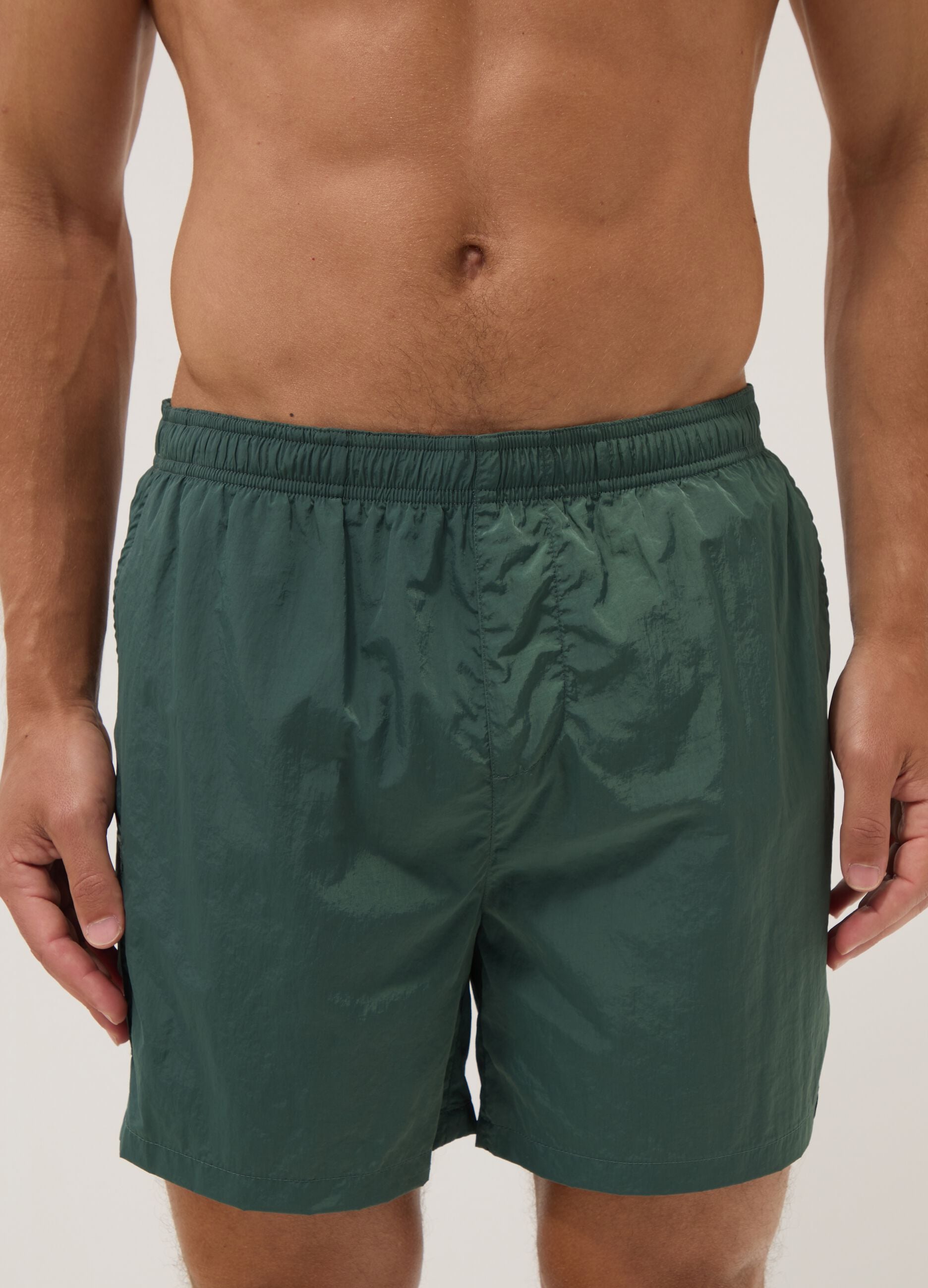 Green swim shorts with elasticated waistband