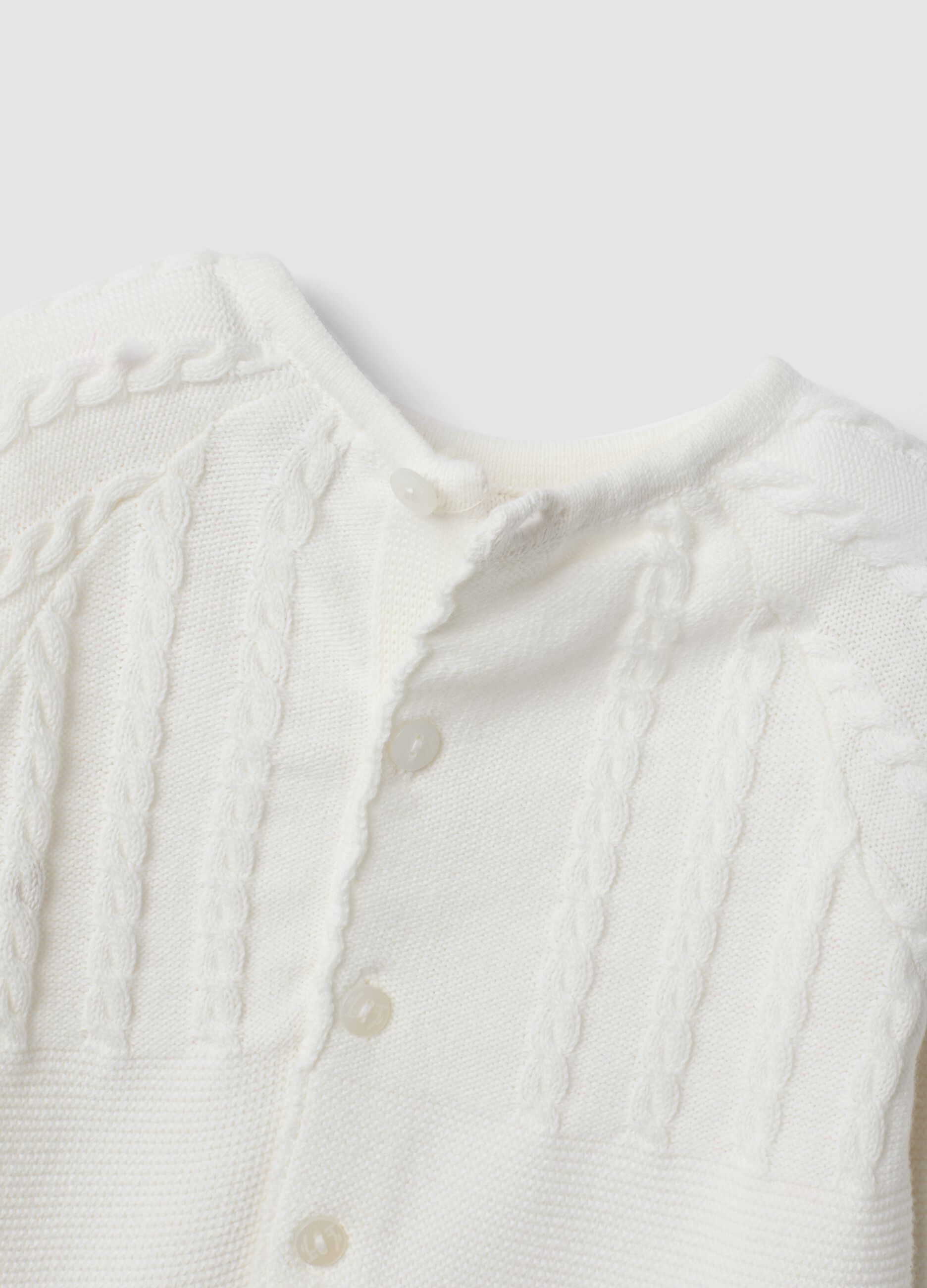 White organic cotton baby sleepsuit with cable knit detail