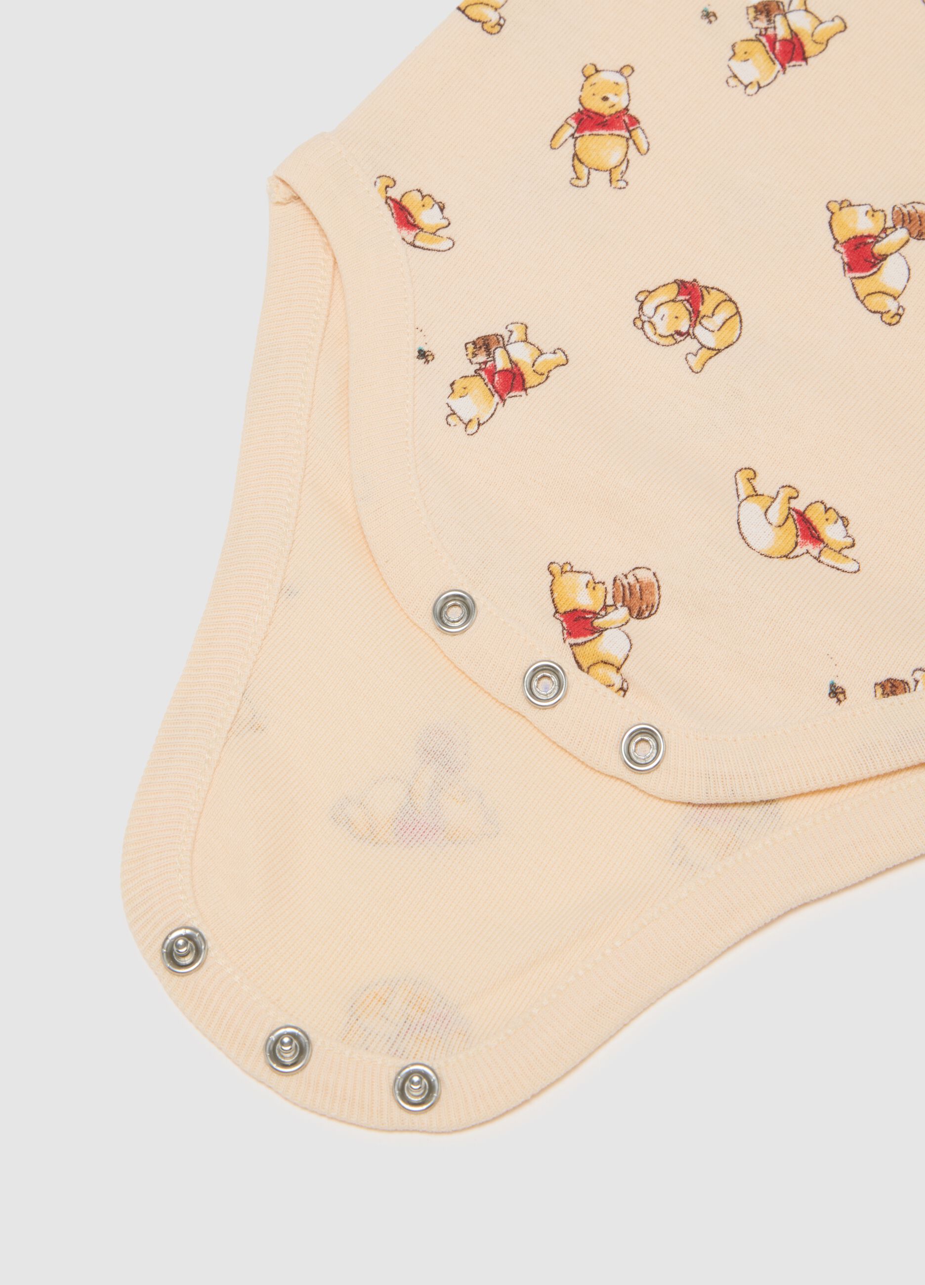Unisex baby bodysuit in pure beige cotton with Winnie the Pooh print