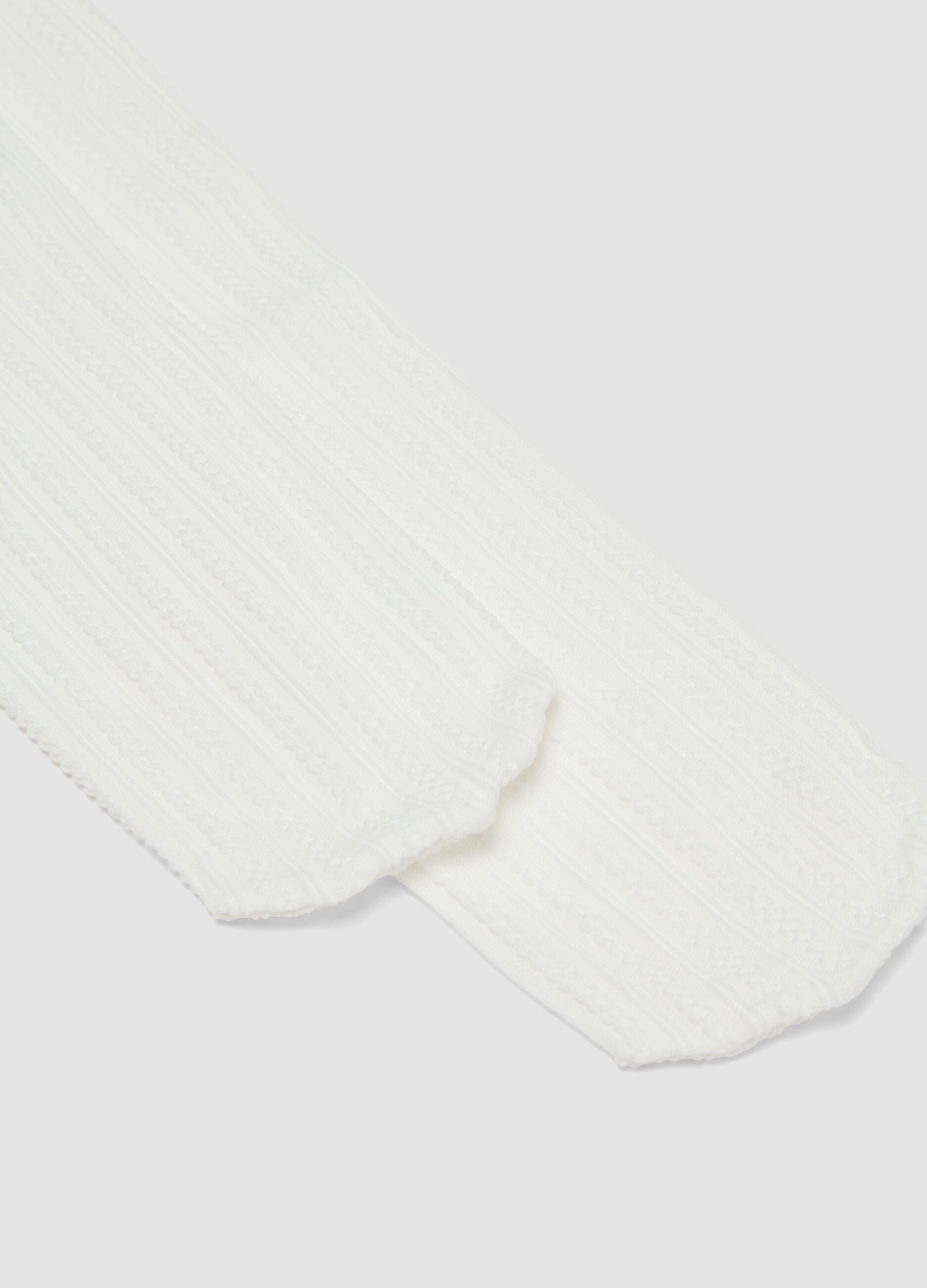 Collant bianco in tessuto elasticizzato con motivo lavorato