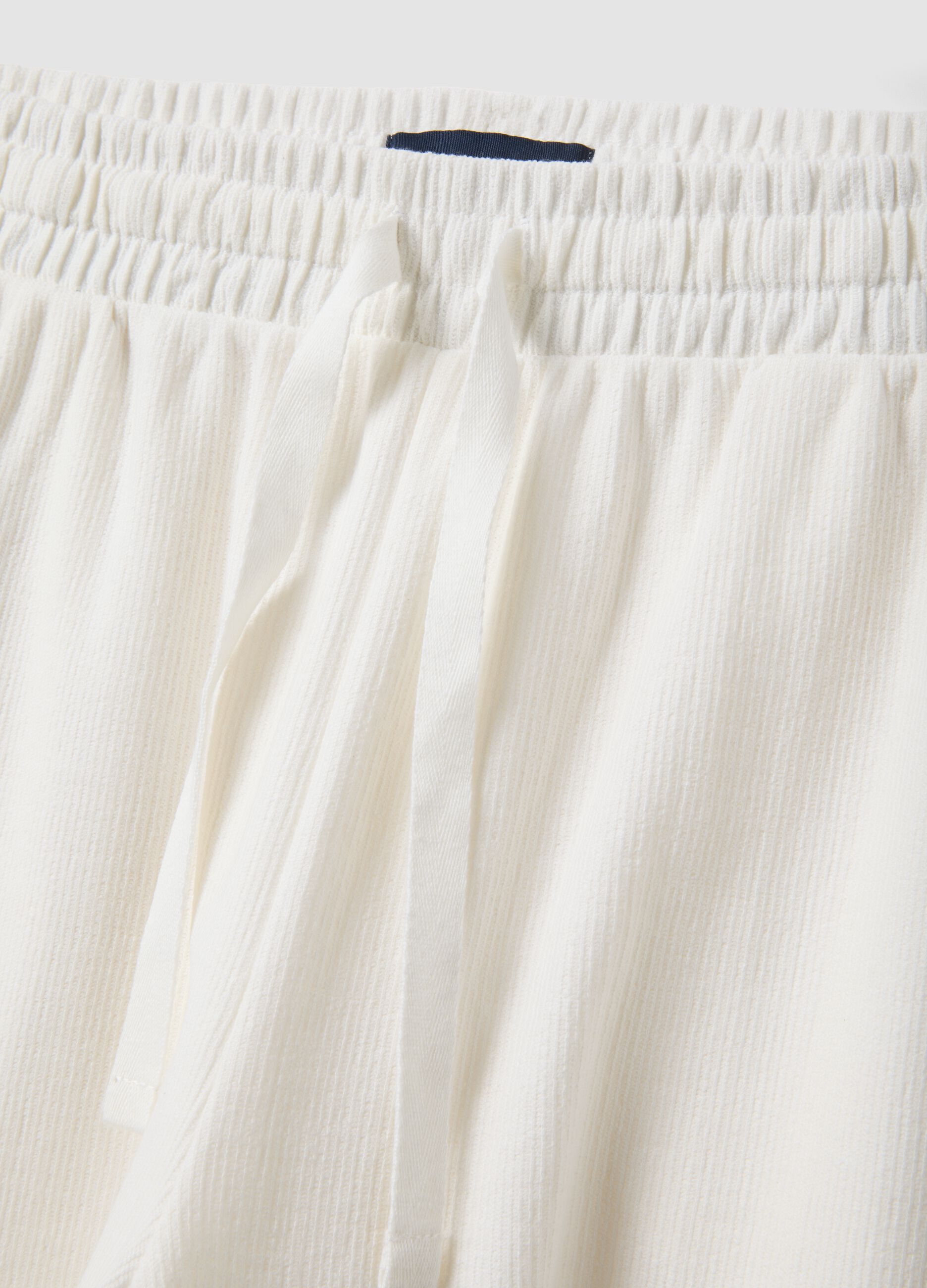 White cotton-blend jogger shorts with drawstring, relaxed fit
