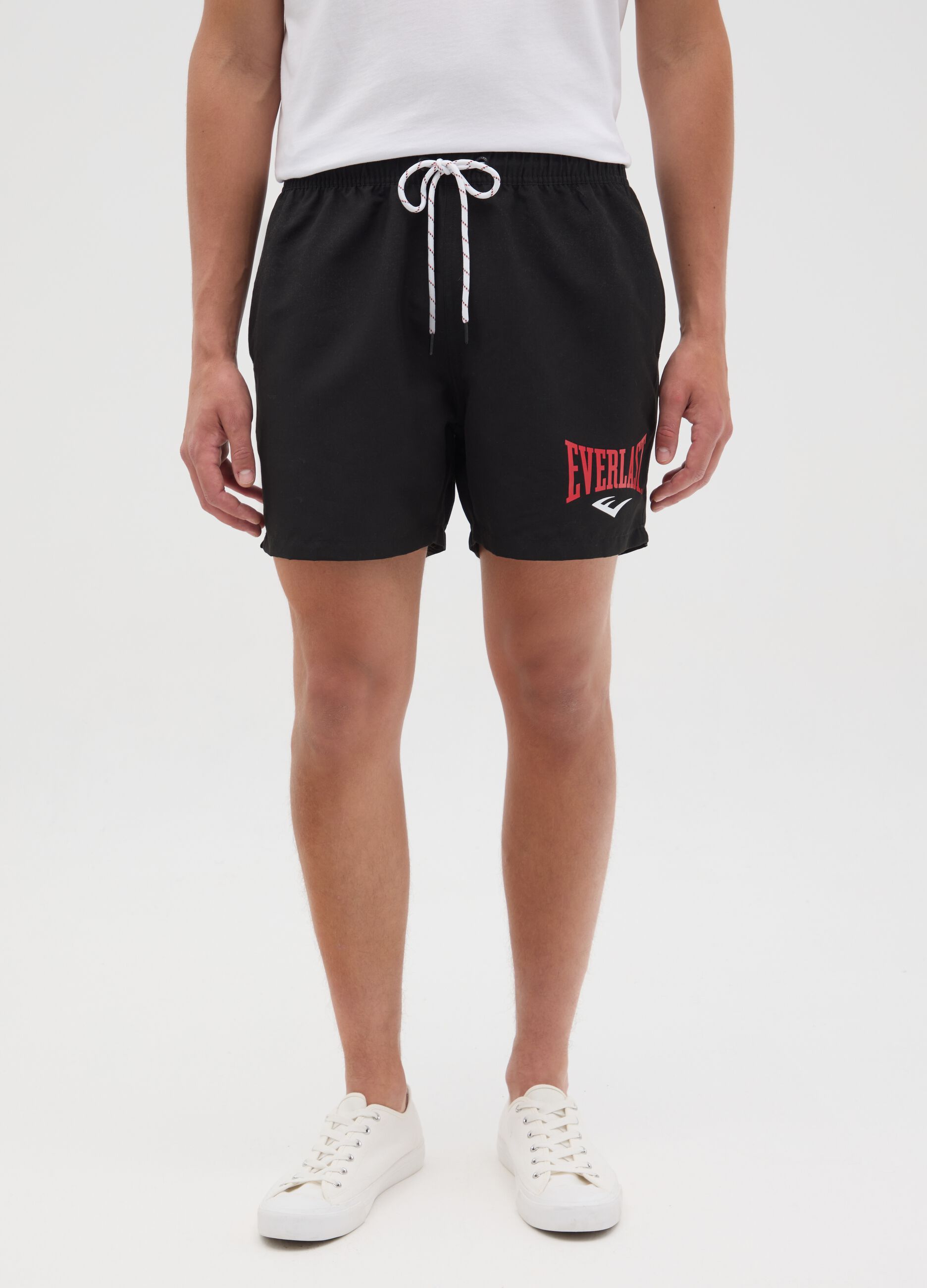 Black swimming trunks with logo print