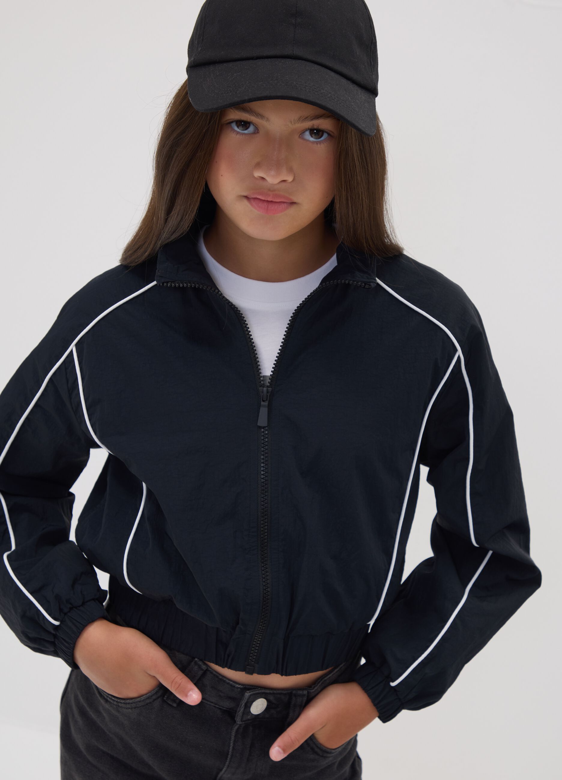 Black zip-up jacket with contrasting piping and high neck for girls