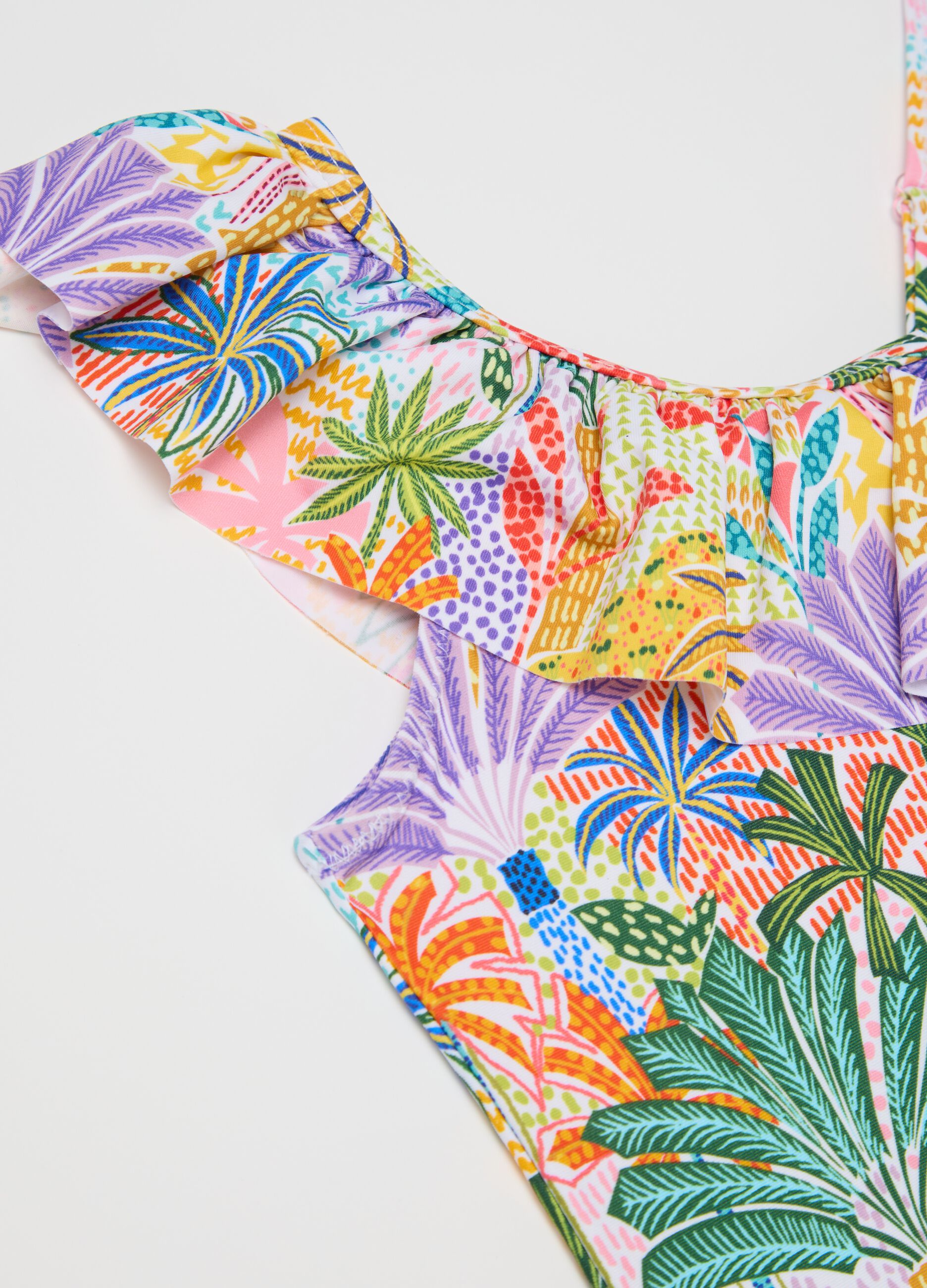 Yellow and purple swimsuit with flounce and tropical print