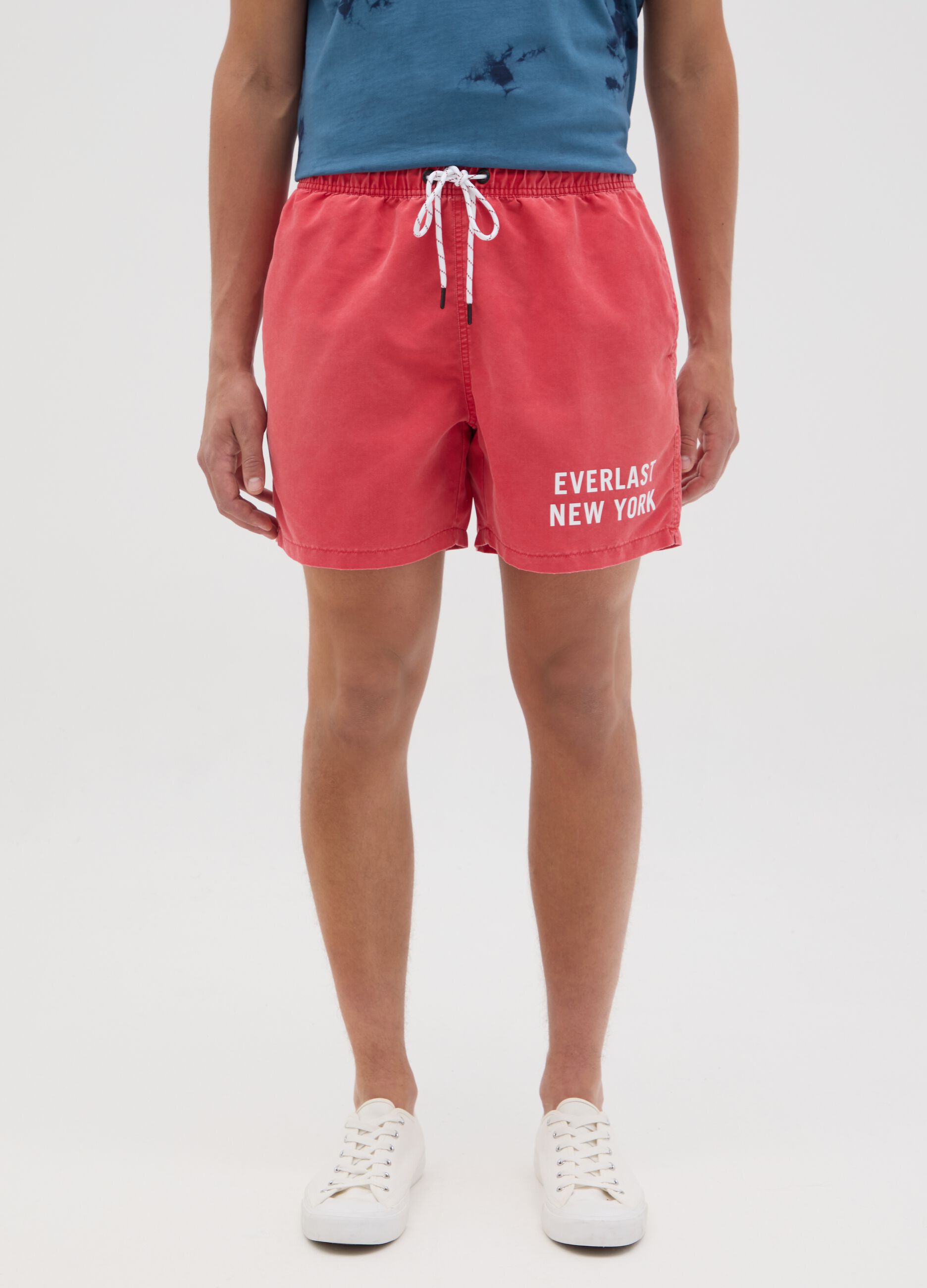 Red swimming trunks with logo print