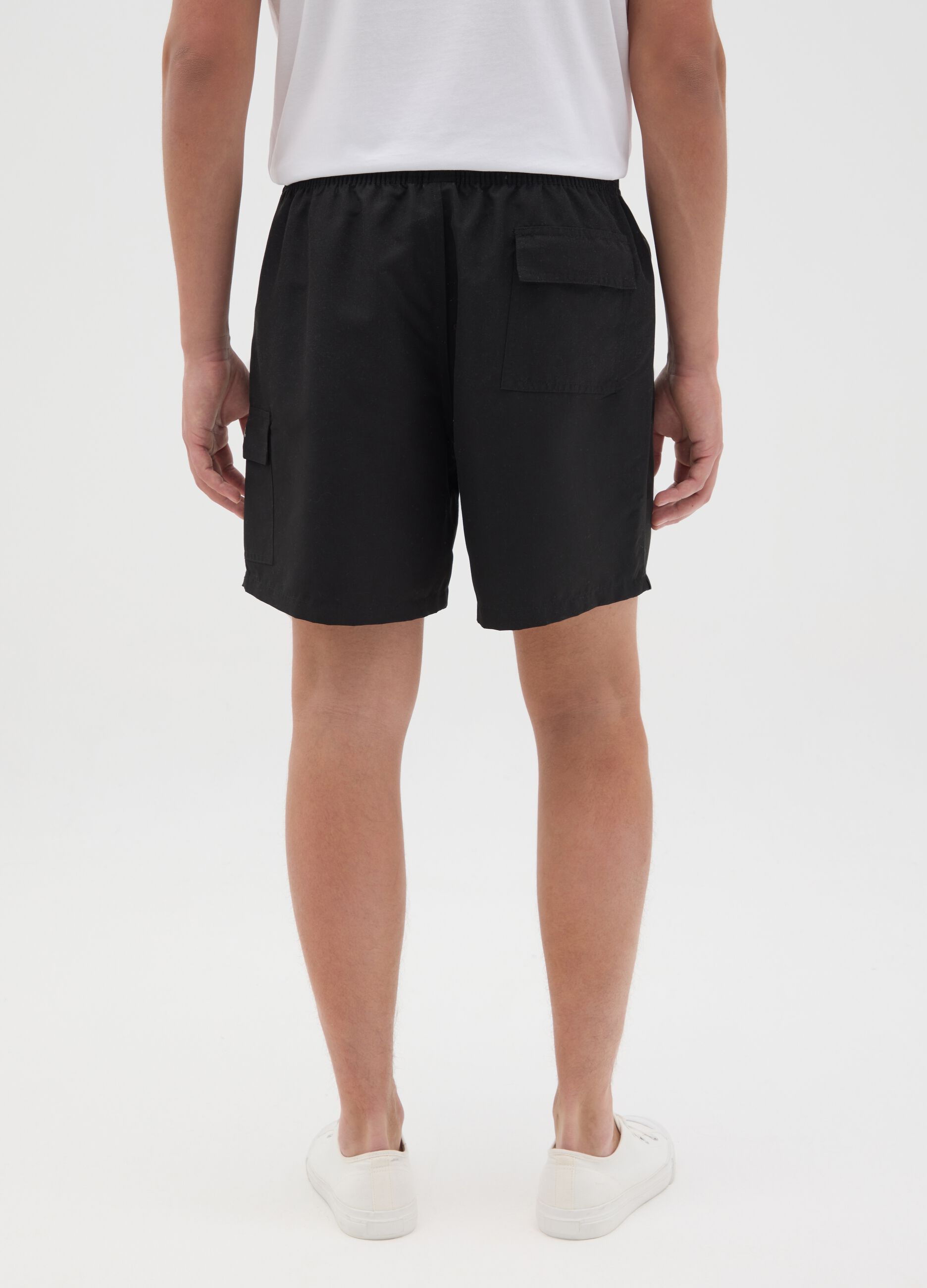 Black swimming trunks with logo print