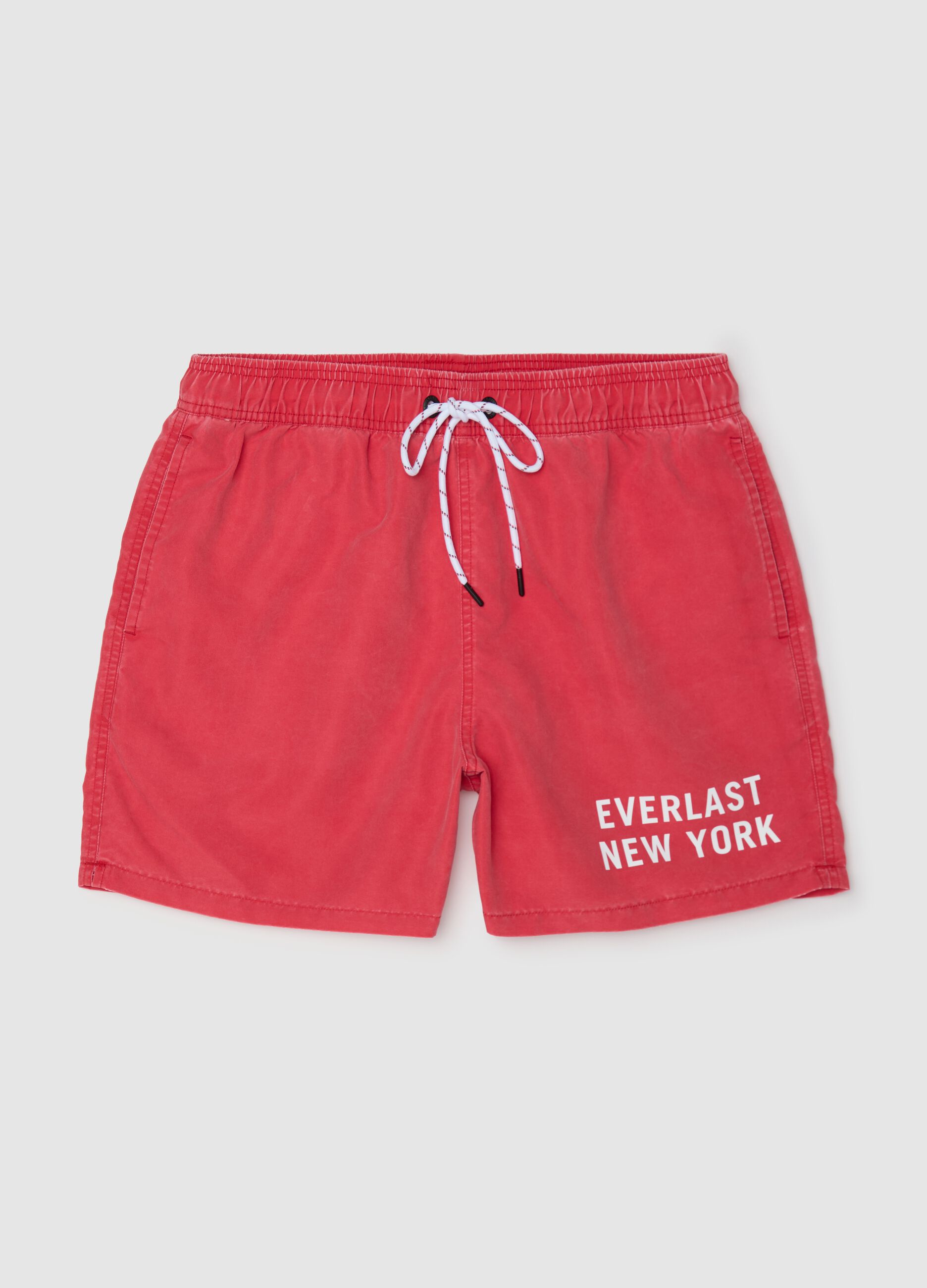 Red swimming trunks with logo print