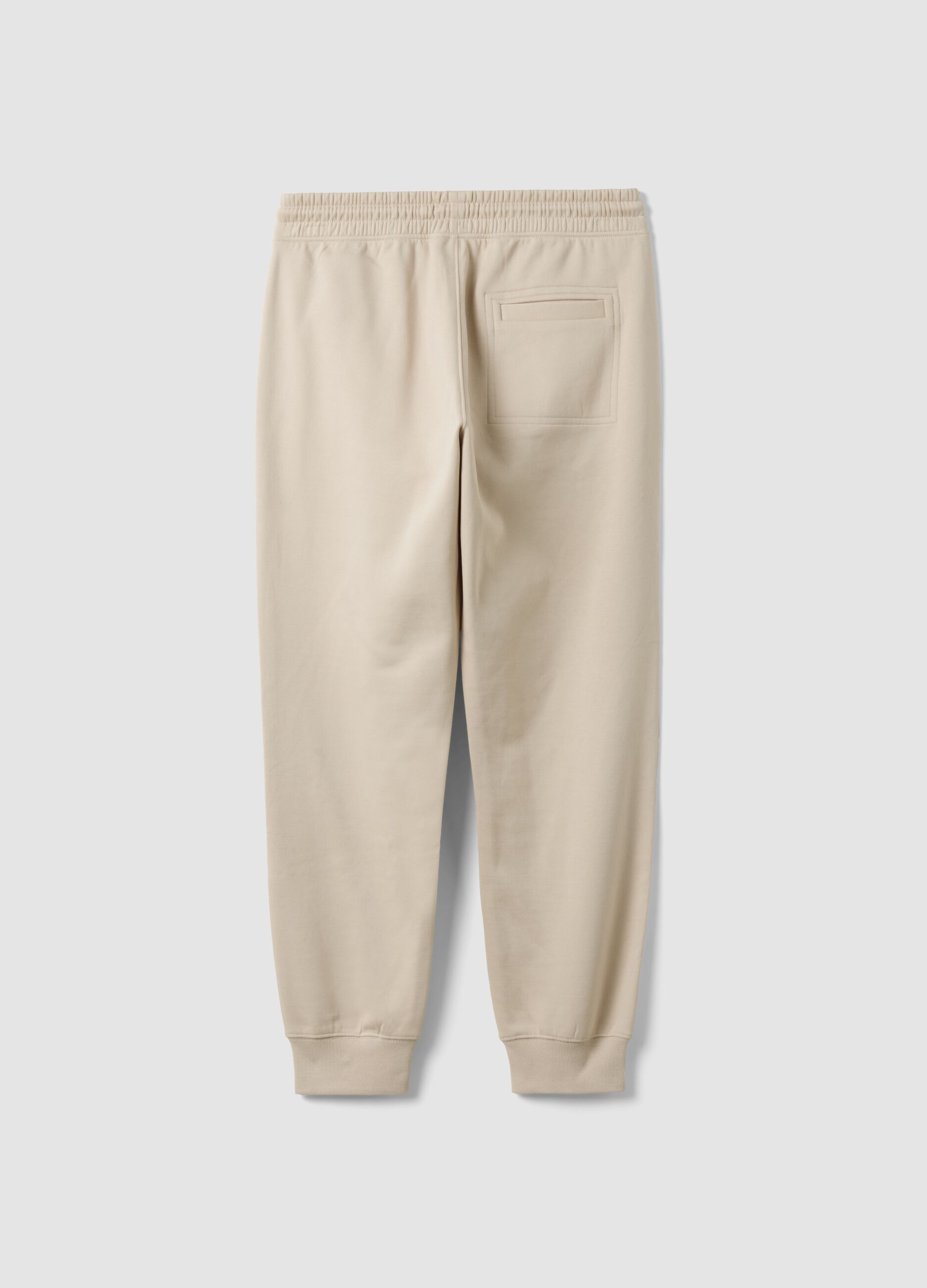 Beige cotton-blend joggers with cuffed hems and drawstring