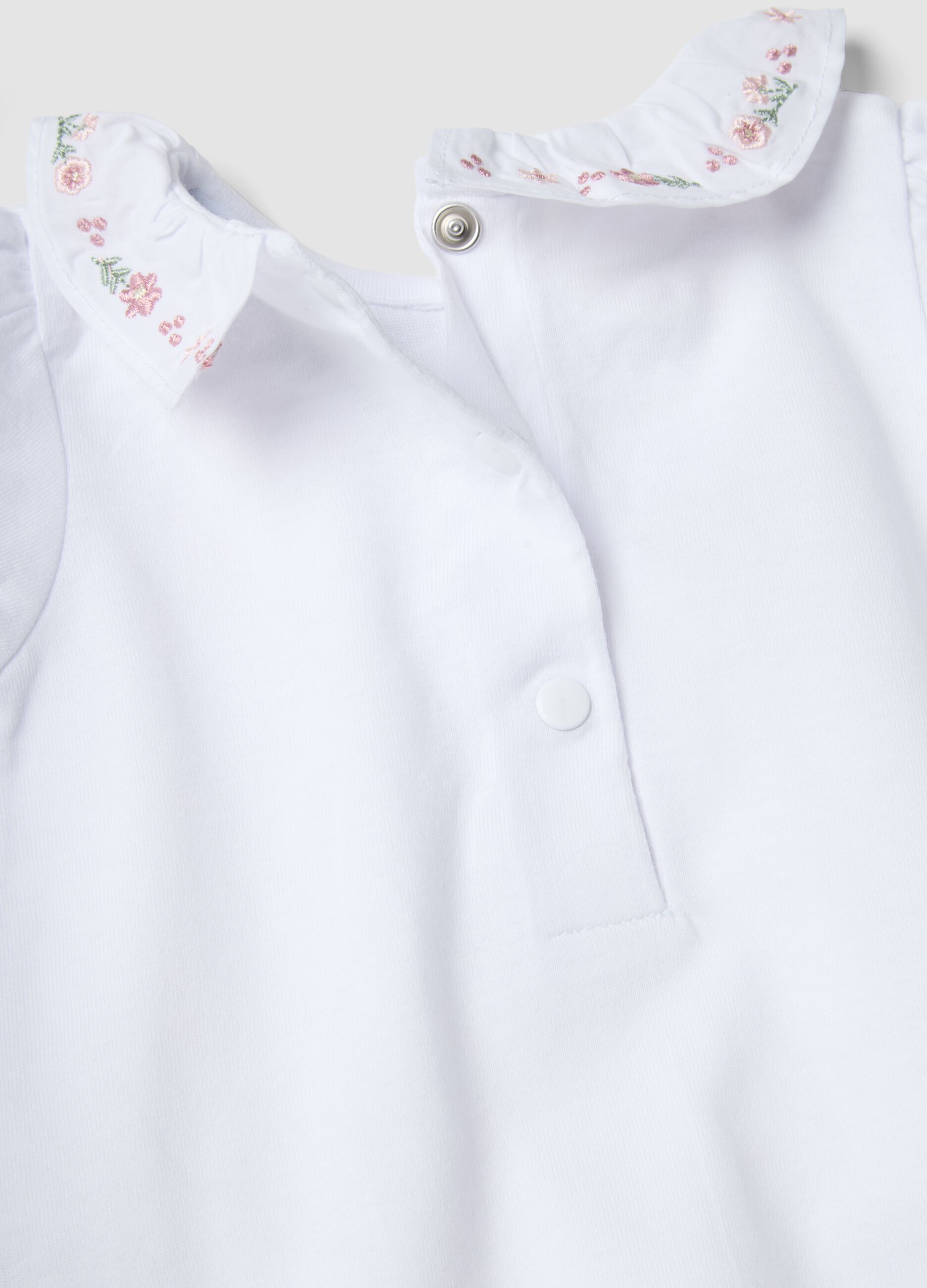 White organic cotton baby bodysuit with ruffled collar