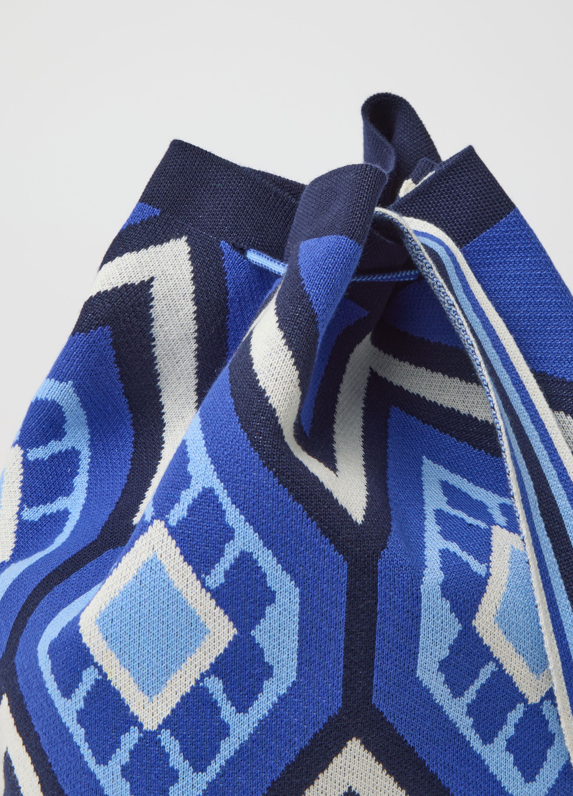Shoulder bag with geometric motif and tassels