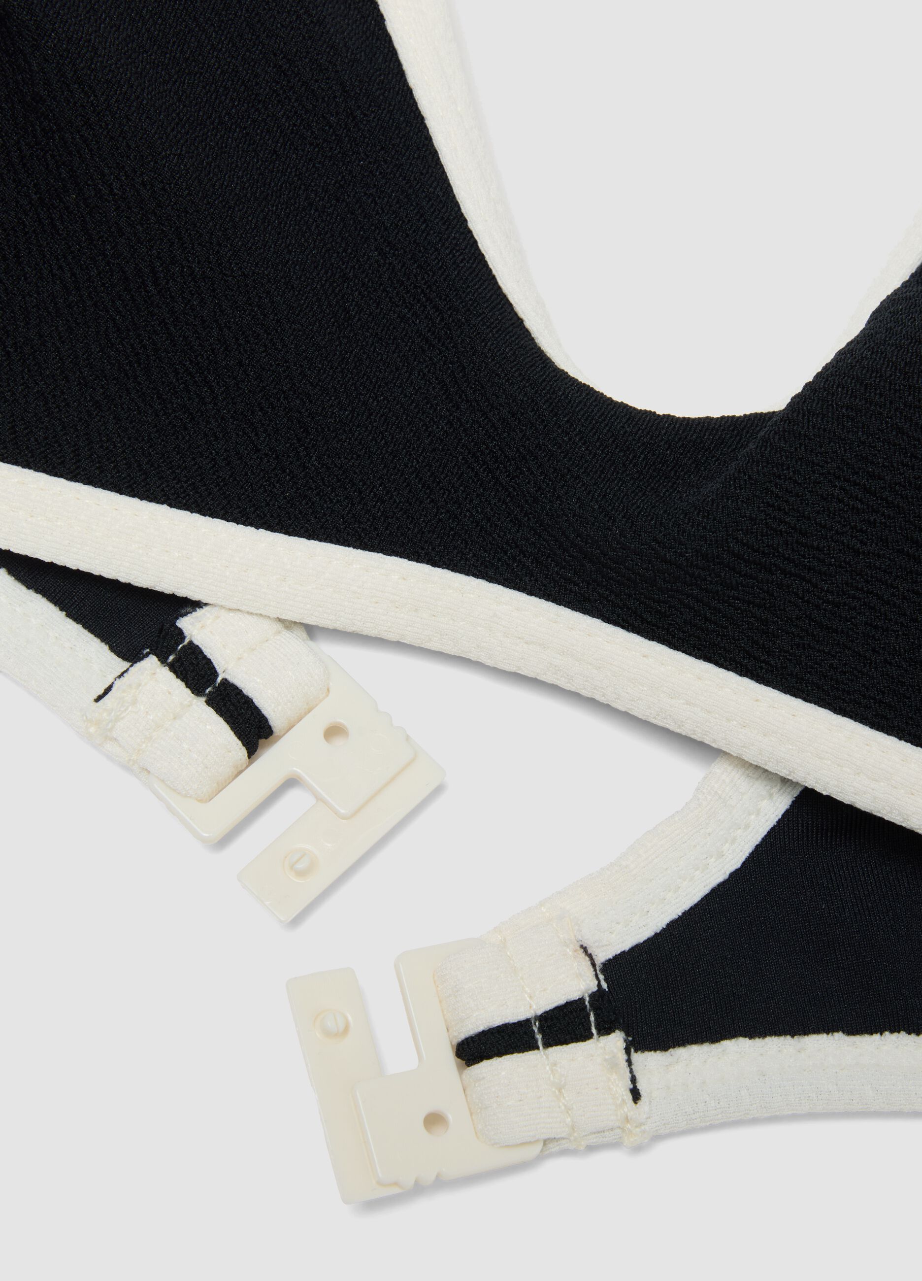 Black stretch fabric bikini top with white trim